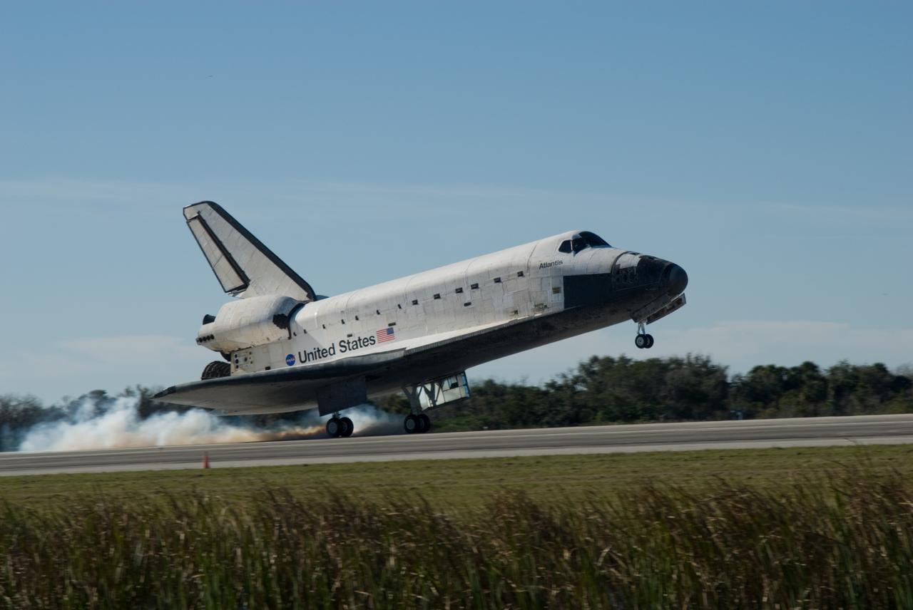 CAPE CANAVERAL, Fla. - Streams of smoke trail from the main landing gear tires as space shuttle Atlantis touches down on Runway 33 at the Shuttle Landing Facility at NASA's Kennedy Space Center in Florida after 11 days in space, completing the 4.5-million-mile STS-129 mission on orbit 171. Main gear touchdown was at 9:44:23 a.m. EST. Nose gear touchdown was at 9:44:36 a.m., and wheels stop was at 9:45:05 a.m. Aboard Atlantis are Commander Charles O. Hobaugh; Pilot Barry E. Wilmore; Mission Specialists Leland Melvin, Randy Bresnik, Mike Foreman and Robert L. Satcher Jr.; and Expedition 20 and 21 Flight Engineer Nicole Stott who spent 87 days aboard the International Space Station. STS-129 is the final space shuttle Expedition crew rotation flight on the manifest. On STS-129, the crew delivered 14 tons of cargo to the orbiting laboratory, including two ExPRESS Logistics Carriers containing spare parts to sustain station operations after the shuttles are retired next year. For information on the STS-129 mission and crew, visit http://www.nasa.gov/mission_pages/shuttle/shuttlemissions/sts129/index.html. Photo credit: NASA/Jim Grossmann