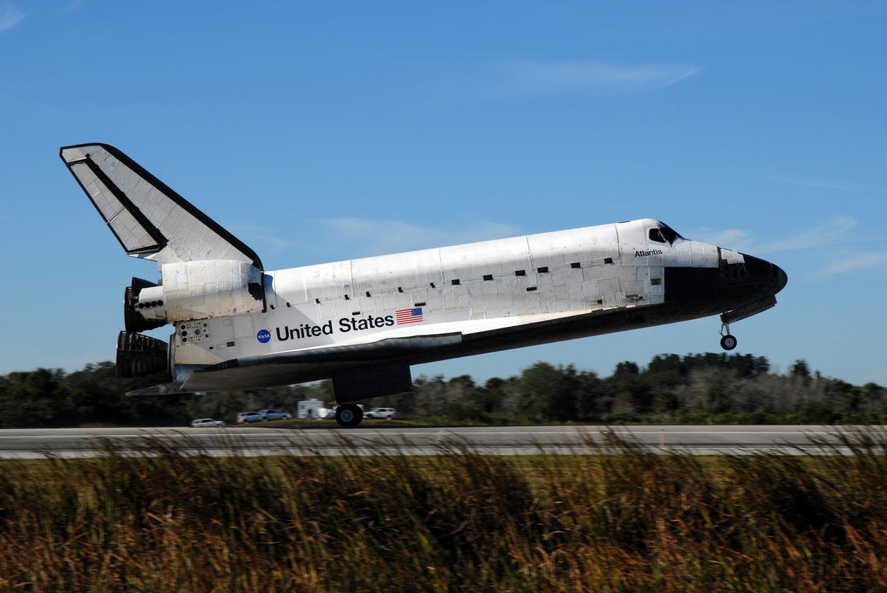 CAPE CANAVERAL, Fla. - Space shuttle Atlantis touches down on Runway 33 at the Shuttle Landing Facility at NASA's Kennedy Space Center in Florida after 11 days in space, completing the 4.5-million mile STS-129 mission on orbit 171.    Main gear touchdown was at 9:44:23 a.m. EST. Nose gear touchdown was at 9:44:36 a.m., and wheels stop was at 9:45:05 a.m. Aboard Atlantis are Commander Charles O. Hobaugh; Pilot Barry E. Wilmore; Mission Specialists Leland Melvin, Randy Bresnik, Mike Foreman and Robert L. Satcher Jr.; and Expedition 20 and 21 Flight Engineer Nicole Stott who spent 87 days aboard the International Space Station. STS-129 is the final space shuttle Expedition crew rotation flight on the manifest. On STS-129, the crew delivered 14 tons of cargo to the orbiting laboratory, including two ExPRESS Logistics Carriers containing spare parts to sustain station operations after the shuttles are retired next year. For information on the STS-129 mission and crew, visit http://www.nasa.gov/mission_pages/shuttle/shuttlemissions/sts129/index.html. Photo credit: NASA/Jim Grossmann