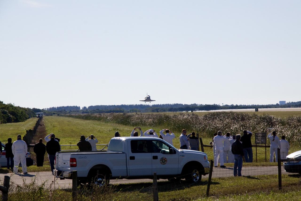 CAPE CANAVERAL, Fla. - Space shuttle workers await landing of shuttle Atlantis on Runway 33 at the Shuttle Landing Facility at NASA's Kennedy Space Center in Florida. After 11 days in space, Atlantis completed the 4.5-million mile STS-129 mission on orbit 171. Main gear touchdown was at 9:44:23 a.m. EST. Nose gear touchdown was at 9:44:36 a.m., and wheels stop was at 9:45:05 a.m. Aboard Atlantis are Commander Charles O. Hobaugh; Pilot Barry E. Wilmore; Mission Specialists Leland Melvin, Randy Bresnik, Mike Foreman and Robert L. Satcher Jr.; and Expedition 20 and 21 Flight Engineer Nicole Stott who spent 87 days aboard the International Space Station. STS-129 is the final space shuttle Expedition crew rotation flight on the manifest. On STS-129, the crew delivered 14 tons of cargo to the orbiting laboratory, including two ExPRESS Logistics Carriers containing spare parts to sustain station operations after the shuttles are retired next year. For information on the STS-129 mission and crew, visit http://www.nasa.gov/mission_pages/shuttle/shuttlemissions/sts129/index.html. Photo credit: NASA/Jack Pfaller