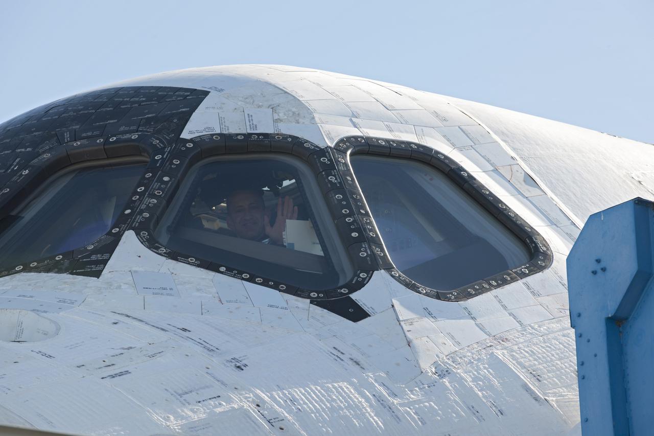 CAPE CANAVERAL, Fla. - STS-129 Commander Charles O. Hobaugh waves from the cockpit of space shuttle Atlantis following a picture-perfect landing at the Shuttle Landing Facility at NASA's Kennedy Space Center in Florida.  After 11 days in space, Atlantis completed the 4.5-million mile STS-129 mission on orbit 171.     Main gear touchdown was at 9:44:23 a.m. EST. Nose gear touchdown was at 9:44:36 a.m., and wheels stop was at 9:45:05 a.m. Other crew members aboard Atlantis are Pilot Barry E. Wilmore; Mission Specialists Leland Melvin, Randy Bresnik, Mike Foreman and Robert L. Satcher Jr.; and Expedition 20 and 21 Flight Engineer Nicole Stott who spent 87 days aboard the International Space Station. STS-129 is the final space shuttle Expedition crew rotation flight on the manifest. On STS-129, the crew delivered 14 tons of cargo to the orbiting laboratory, including two ExPRESS Logistics Carriers containing spare parts to sustain station operations after the shuttles are retired next year. For information on the STS-129 mission and crew, visit http://www.nasa.gov/mission_pages/shuttle/shuttlemissions/sts129/index.html. Photo credit: NASA/Jeff Wolfe