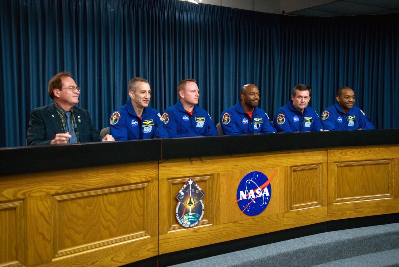 CAPE CANAVERAL, Fla. - Crew members of space shuttle Atlantis' STS-129 mission participate in a news conference in the NASA Press Site auditorium at NASA's Kennedy Space Center in Florida on landing day.  From left are NASA Public Affairs moderator George Diller; Commander Charles O. Hobaugh; Pilot Barry E. Wilmore; and Mission Specialists Leland Melvin, Mike Foreman and Robert L. Satcher Jr.  Not participating is Mission Specialist Randy Bresnik who left for Houston earlier in the day, anxious to meet his new daughter who was born during the mission. Atlantis' main gear touchdown on Kennedy's Shuttle Landing Facility was at 9:44:23 a.m. EST. Nose gear touchdown was at 9:44:36 a.m., and wheels stop was at 9:45:05 a.m.  Expedition 20 and 21 Flight Engineer Nicole Stott, who spent 87 days on the International Space Station, also returned from orbit aboard Atlantis.  STS-129 is the final space shuttle Expedition crew rotation flight on the manifest.  On STS-129, the crew delivered 14 tons of cargo to the orbiting laboratory, including two ExPRESS Logistics Carriers containing spare parts to sustain station operations after the shuttles are retired next year.  For information on the STS-129 mission and crew, visit http://www.nasa.gov/mission_pages/shuttle/shuttlemissions/sts129/index.html. Photo credit: NASA/Kim Shiflett