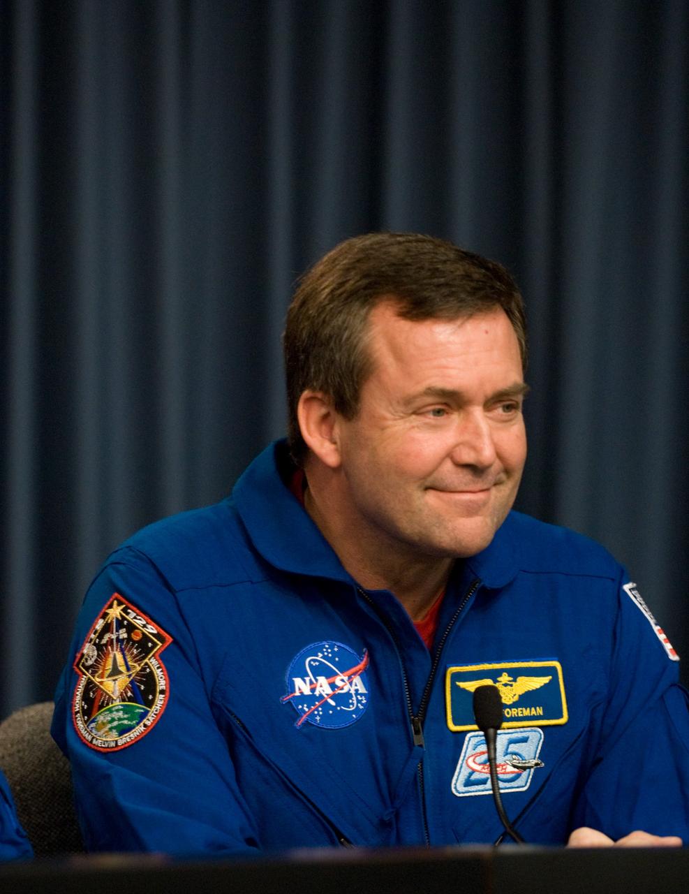CAPE CANAVERAL, Fla. - STS-129 Mission Specialist Mike Foreman participates in a news conference in the NASA Press Site auditorium at NASA's Kennedy Space Center in Florida on landing day. Space shuttle Atlantis' main gear touchdown on Kennedy's Shuttle Landing Facility was at 9:44:23 a.m. EST. Nose gear touchdown was at 9:44:36 a.m., and wheels stop was at 9:45:05 a.m. STS-129 is the final space shuttle Expedition crew rotation flight on the manifest. On STS-129, the crew delivered 14 tons of cargo to the orbiting laboratory, including two ExPRESS Logistics Carriers containing spare parts to sustain station operations after the shuttles are retired next year. For information on the STS-129 mission and crew, visit http://www.nasa.gov/mission_pages/shuttle/shuttlemissions/sts129/index.html. Photo credit: NASA/Kim Shiflett