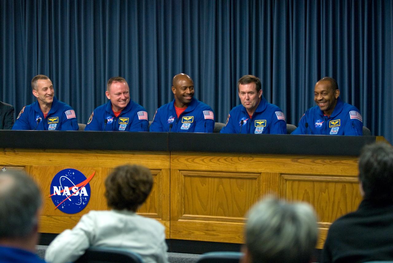 CAPE CANAVERAL, Fla. - Crew members of space shuttle Atlantis' STS-129 mission participate in a news conference in the NASA Press Site auditorium at NASA's Kennedy Space Center in Florida on landing day. From left are Commander Charles O. Hobaugh; Pilot Barry E. Wilmore; and Mission Specialists Leland Melvin, Mike Foreman and Robert L. Satcher Jr. Not participating is Mission Specialist Randy Bresnik who left for Houston earlier in the day, anxious to meet his new daughter who was born during the mission. Atlantis' main gear touchdown on Kennedy's Shuttle Landing Facility was at 9:44:23 a.m. EST. Nose gear touchdown was at 9:44:36 a.m., and wheels stop was at 9:45:05 a.m. Expedition 20 and 21 Flight Engineer Nicole Stott, who spent 87 days on the International Space Station, also returned from orbit aboard Atlantis. STS-129 is the final space shuttle Expedition crew rotation flight on the manifest. On STS-129, the crew delivered 14 tons of cargo to the orbiting laboratory, including two ExPRESS Logistics Carriers containing spare parts to sustain station operations after the shuttles are retired next year. For information on the STS-129 mission and crew, visit http://www.nasa.gov/mission_pages/shuttle/shuttlemissions/sts129/index.html. Photo credit: NASA/Kim Shiflett