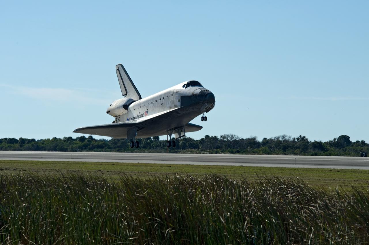CAPE CANAVERAL, Fla. - With landing gear down, space shuttle Atlantis nears touch down on Runway 33 at the Shuttle Landing Facility at NASA's Kennedy Space Center in Florida after 11 days in space, completing the 4.5-million mile STS-129 mission on orbit 171.    Main gear touchdown was at 9:44:23 a.m. EST. Nose gear touchdown was at 9:44:36 a.m., and wheels stop was at 9:45:05 a.m.  Aboard Atlantis are Commander Charles O. Hobaugh; Pilot Barry E. Wilmore; Mission Specialists Leland Melvin, Randy Bresnik, Mike Foreman and Robert L. Satcher Jr.; and Expedition 20 and 21 Flight Engineer Nicole Stott who spent 87 days aboard the International Space Station.  STS-129 is the final space shuttle Expedition crew rotation flight on the manifest.  On STS-129, the crew delivered 14 tons of cargo to the orbiting laboratory, including two ExPRESS Logistics Carriers containing spare parts to sustain station operations after the shuttles are retired next year.  For information on the STS-129 mission and crew, visit http://www.nasa.gov/mission_pages/shuttle/shuttlemissions/sts129/index.html.     Photo credit: NASA/Carl Winebarger