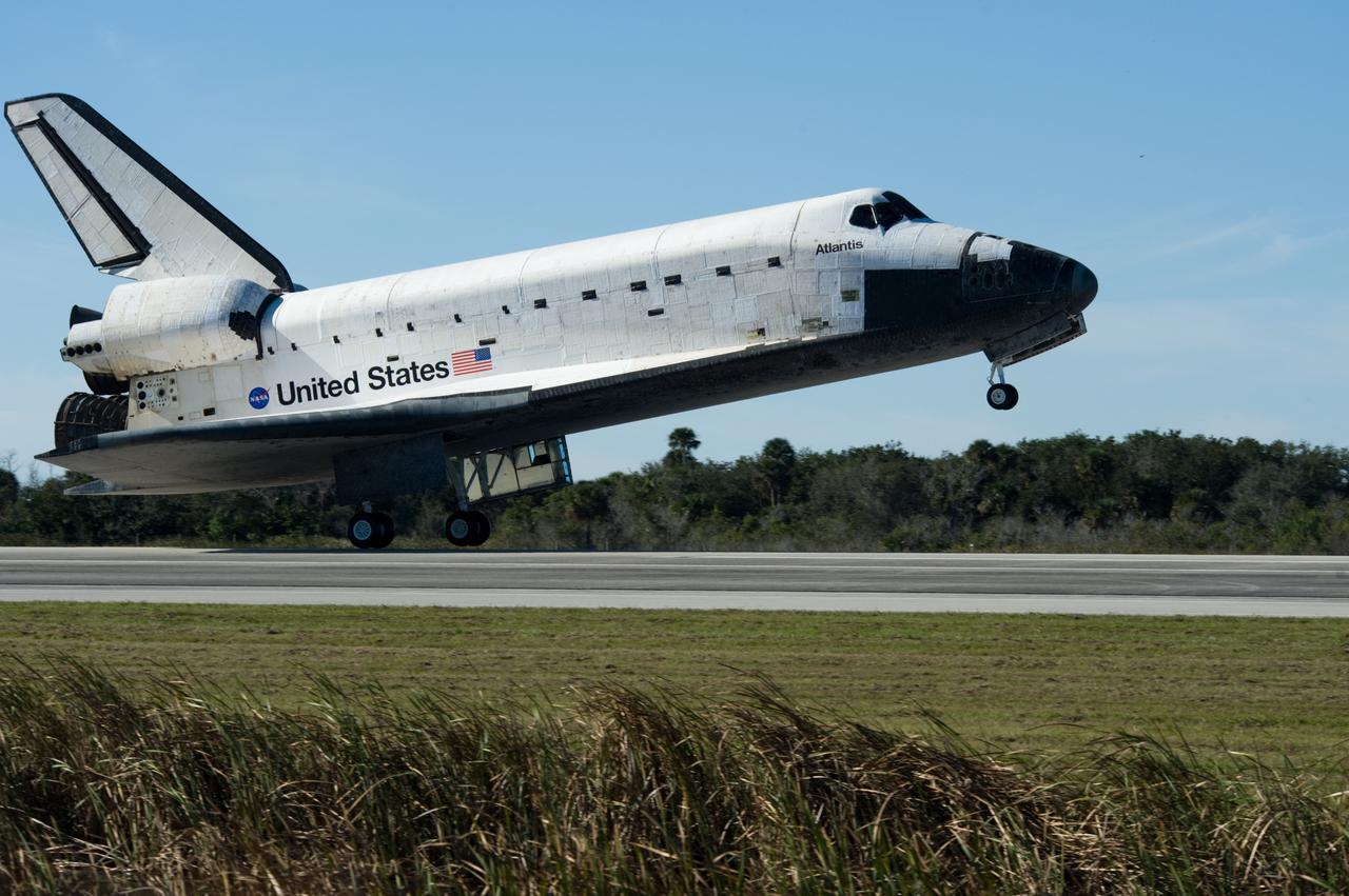 CAPE CANAVERAL, Fla. - Space shuttle Atlantis' main landing gear tires near contact with Runway 33 at the Shuttle Landing Facility at NASA's Kennedy Space Center in Florida after 11 days in space, completing the 4.5-million mile STS-129 mission on orbit 171.    Main gear touchdown was at 9:44:23 a.m. EST. Nose gear touchdown was at 9:44:36 a.m., and wheels stop was at 9:45:05 a.m.  Aboard Atlantis are Commander Charles O. Hobaugh; Pilot Barry E. Wilmore; Mission Specialists Leland Melvin, Randy Bresnik, Mike Foreman and Robert L. Satcher Jr.; and Expedition 20 and 21 Flight Engineer Nicole Stott who spent 87 days aboard the International Space Station.  STS-129 is the final space shuttle Expedition crew rotation flight on the manifest.  On STS-129, the crew delivered 14 tons of cargo to the orbiting laboratory, including two ExPRESS Logistics Carriers containing spare parts to sustain station operations after the shuttles are retired next year.  For information on the STS-129 mission and crew, visit http://www.nasa.gov/mission_pages/shuttle/shuttlemissions/sts129/index.html.     Photo credit: NASA/Carl Winebarger