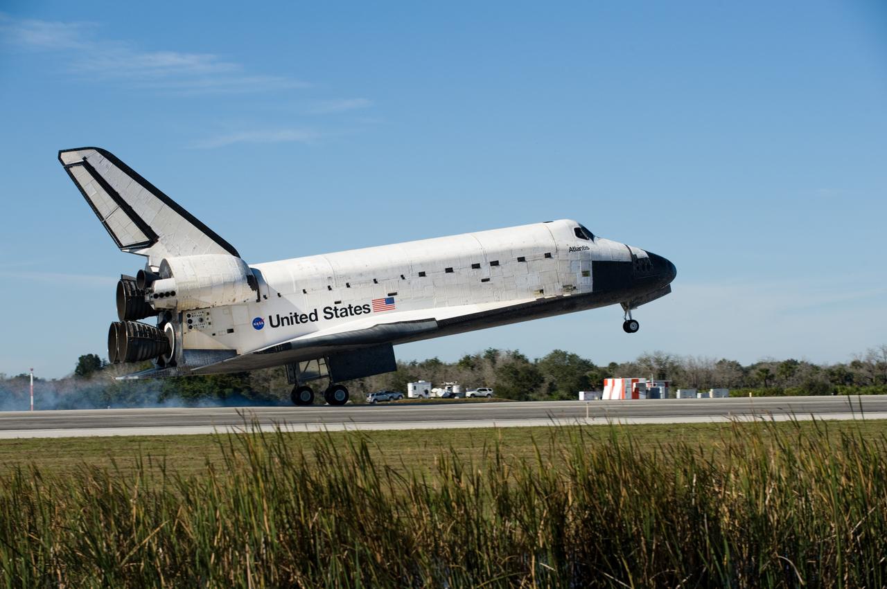 CAPE CANAVERAL, Fla. - The tires of space shuttle Atlantis' main landing gear make contact with Runway 33 at the Shuttle Landing Facility at NASA's Kennedy Space Center in Florida after 11 days in space, completing the 4.5-million mile STS-129 mission on orbit 171.    Main gear touchdown was at 9:44:23 a.m. EST. Nose gear touchdown was at 9:44:36 a.m., and wheels stop was at 9:45:05 a.m.  Aboard Atlantis are Commander Charles O. Hobaugh; Pilot Barry E. Wilmore; Mission Specialists Leland Melvin, Randy Bresnik, Mike Foreman and Robert L. Satcher Jr.; and Expedition 20 and 21 Flight Engineer Nicole Stott who spent 87 days aboard the International Space Station.  STS-129 is the final space shuttle Expedition crew rotation flight on the manifest.  On STS-129, the crew delivered 14 tons of cargo to the orbiting laboratory, including two ExPRESS Logistics Carriers containing spare parts to sustain station operations after the shuttles are retired next year.  For information on the STS-129 mission and crew, visit http://www.nasa.gov/mission_pages/shuttle/shuttlemissions/sts129/index.html.     Photo credit: NASA/Thomas Farrar Jr.