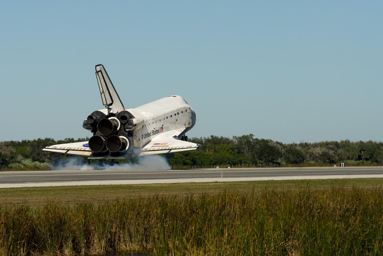 CAPE CANAVERAL, Fla. - Space shuttle Atlantis kicks up the dust on Runway 33 as it touches down at the Shuttle Landing Facility at NASA's Kennedy Space Center in Florida after 11 days in space, completing the 4.5-million mile STS-129 mission on orbit 171.    Main gear touchdown was at 9:44:23 a.m. EST. Nose gear touchdown was at 9:44:36 a.m., and wheels stop was at 9:45:05 a.m.  Aboard Atlantis are Commander Charles O. Hobaugh; Pilot Barry E. Wilmore; Mission Specialists Leland Melvin, Randy Bresnik, Mike Foreman and Robert L. Satcher Jr.; and Expedition 20 and 21 Flight Engineer Nicole Stott who spent 87 days aboard the International Space Station.  STS-129 is the final space shuttle Expedition crew rotation flight on the manifest.  On STS-129, the crew delivered 14 tons of cargo to the orbiting laboratory, including two ExPRESS Logistics Carriers containing spare parts to sustain station operations after the shuttles are retired next year.  For information on the STS-129 mission and crew, visit http://www.nasa.gov/mission_pages/shuttle/shuttlemissions/sts129/index.html.     Photo credit: NASA/Ben Cooper