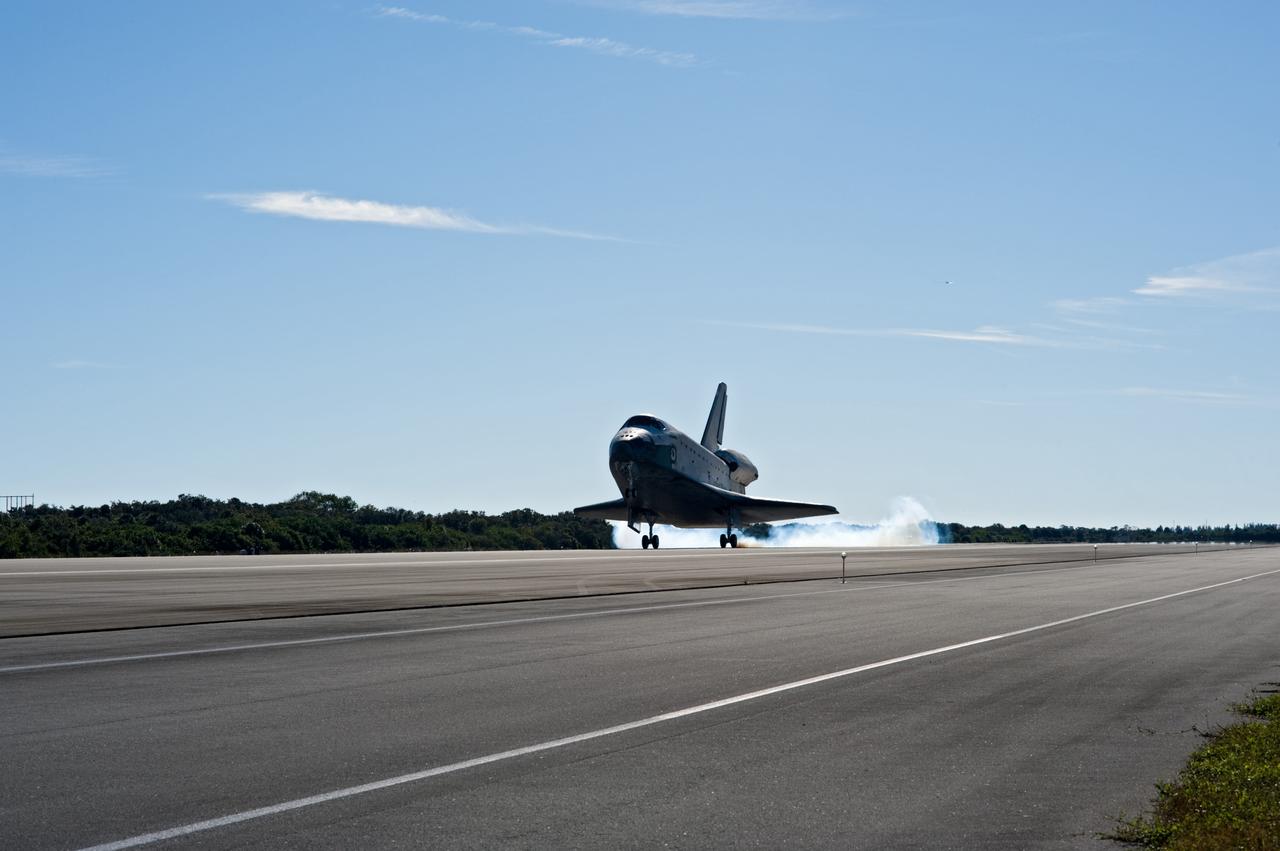 CAPE CANAVERAL, Fla. - Streams of smoke trail from the main landing gear tires as space shuttle Atlantis touches down on Runway 33 at the Shuttle Landing Facility at NASA's Kennedy Space Center in Florida after 11 days in space, completing the 4.5-million-mile STS-129 mission on orbit 171.    Main gear touchdown was at 9:44:23 a.m. EST. Nose gear touchdown was at 9:44:36 a.m., and wheels stop was at 9:45:05 a.m.  Aboard Atlantis are Commander Charles O. Hobaugh; Pilot Barry E. Wilmore; Mission Specialists Leland Melvin, Randy Bresnik, Mike Foreman and Robert L. Satcher Jr.; and Expedition 20 and 21 Flight Engineer Nicole Stott who spent 87 days aboard the International Space Station.  STS-129 is the final space shuttle Expedition crew rotation flight on the manifest.  On STS-129, the crew delivered 14 tons of cargo to the orbiting laboratory, including two ExPRESS Logistics Carriers containing spare parts to sustain station operations after the shuttles are retired next year.  For information on the STS-129 mission and crew, visit http://www.nasa.gov/mission_pages/shuttle/shuttlemissions/sts129/index.html.     Photo credit: NASA/Kevin O'Connell and Rick Prickett