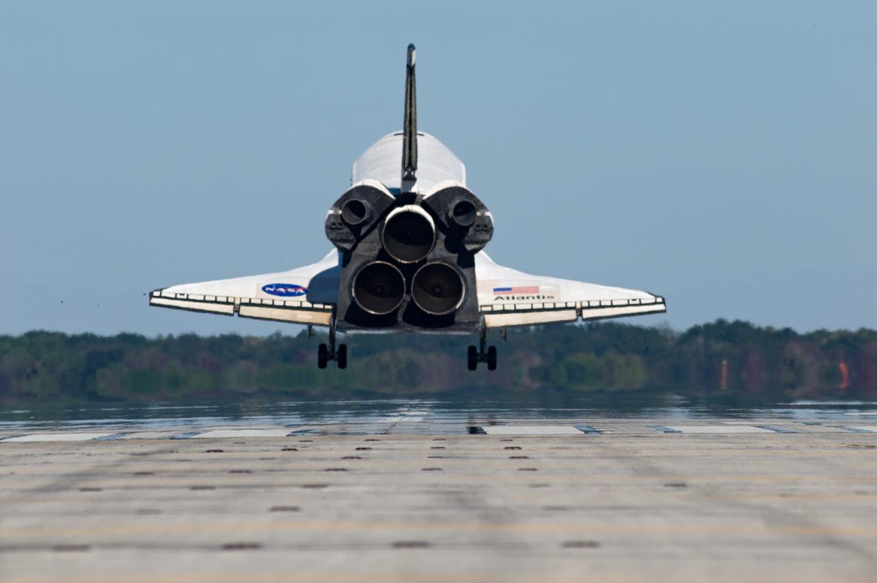 CAPE CANAVERAL, Fla. - With landing gear down, space shuttle Atlantis nears touch down on Runway 33 at the Shuttle Landing Facility at NASA's Kennedy Space Center in Florida after 11 days in space, completing the 4.5-million mile STS-129 mission on orbit 171.    Main gear touchdown was at 9:44:23 a.m. EST. Nose gear touchdown was at 9:44:36 a.m., and wheels stop was at 9:45:05 a.m.  Aboard Atlantis are Commander Charles O. Hobaugh; Pilot Barry E. Wilmore; Mission Specialists Leland Melvin, Randy Bresnik, Mike Foreman and Robert L. Satcher Jr.; and Expedition 20 and 21 Flight Engineer Nicole Stott who spent 87 days aboard the International Space Station.  STS-129 is the final space shuttle Expedition crew rotation flight on the manifest.  On STS-129, the crew delivered 14 tons of cargo to the orbiting laboratory, including two ExPRESS Logistics Carriers containing spare parts to sustain station operations after the shuttles are retired next year.  For information on the STS-129 mission and crew, visit http://www.nasa.gov/mission_pages/shuttle/shuttlemissions/sts129/index.html.     Photo credit: NASA/Kevin O'Connell and Rick Prickett