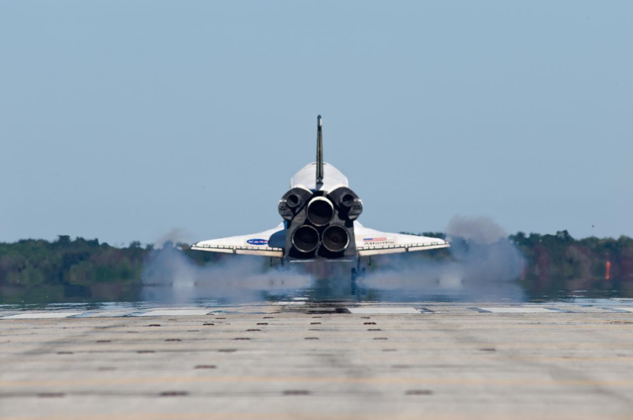 CAPE CANAVERAL, Fla. - Touchdown is apparent by the cloud of dust kicked up by space shuttle Atlantis as its main landing gear tires contact Runway 33 at the Shuttle Landing Facility at NASA's Kennedy Space Center in Florida.  After 11 days in space, Atlantis' 4.5-million-mile STS-129 mission is completed on orbit 171.    Main gear touchdown was at 9:44:23 a.m. EST. Nose gear touchdown was at 9:44:36 a.m., and wheels stop was at 9:45:05 a.m.  Aboard Atlantis are Commander Charles O. Hobaugh; Pilot Barry E. Wilmore; Mission Specialists Leland Melvin, Randy Bresnik, Mike Foreman and Robert L. Satcher Jr.; and Expedition 20 and 21 Flight Engineer Nicole Stott who spent 87 days aboard the International Space Station.  STS-129 is the final space shuttle Expedition crew rotation flight on the manifest.  On STS-129, the crew delivered 14 tons of cargo to the orbiting laboratory, including two ExPRESS Logistics Carriers containing spare parts to sustain station operations after the shuttles are retired next year.  For information on the STS-129 mission and crew, visit http://www.nasa.gov/mission_pages/shuttle/shuttlemissions/sts129/index.html.     Photo credit: NASA/Kevin O'Connell and Rick Prickett