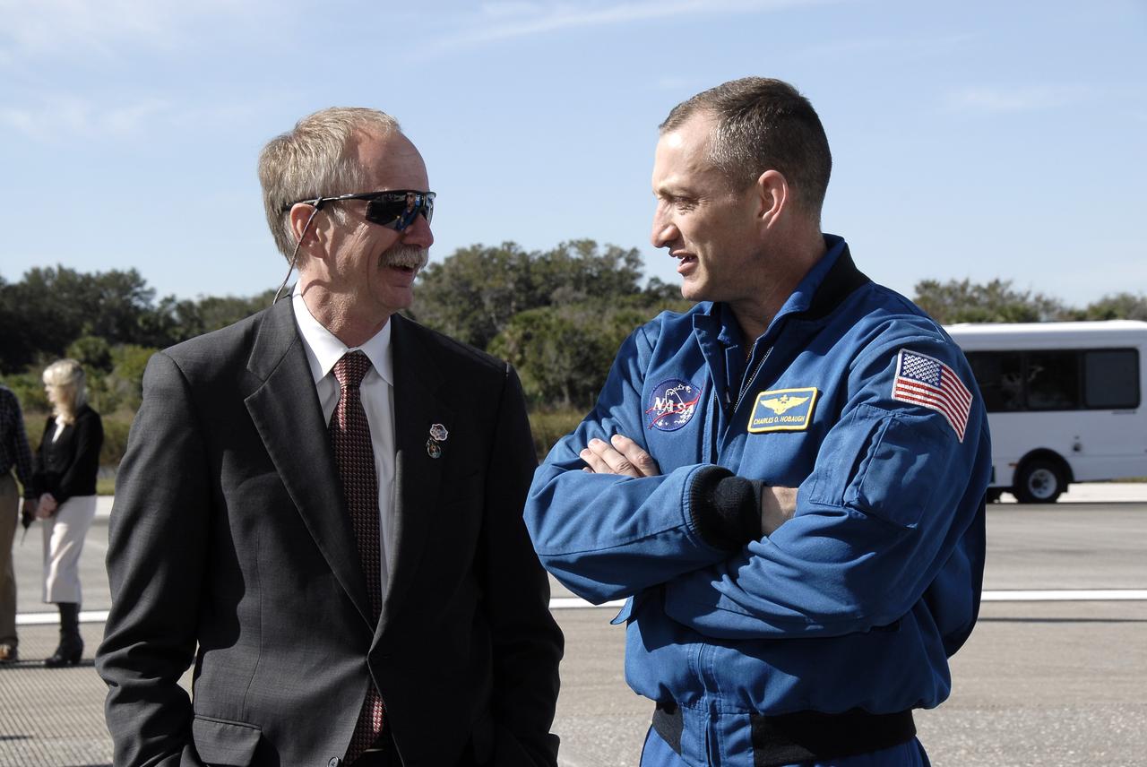 CAPE CANAVERAL, Fla. - At the Shuttle Landing Facility at NASA's Kennedy Space Center in Florida, NASA Associate Administrator for Space Operations Bill Gerstenmaier, left, discusses the picture-perfect landing with STS-129 Commander Charles O. Hobaugh.  Space shuttle Atlantis touched down on Runway 33 with Hobaugh at the controls, completing the 4.5-million-mile STS-129 mission to the International Space Station on orbit 171.  Main gear touchdown was at 9:44:23 a.m. EST. Nose gear touchdown was at 9:44:36 a.m., and wheels stop was at 9:45:05 a.m.  On STS-129, the six-member crew delivered 14 tons of cargo to the orbiting laboratory, including two ExPRESS Logistics Carriers containing spare parts to sustain station operations after the shuttles are retired next year.  For information on the STS-129 mission and crew, visit http://www.nasa.gov/mission_pages/shuttle/shuttlemissions/sts129/index.html.    Photo credit: NASA/Kim Shiflett