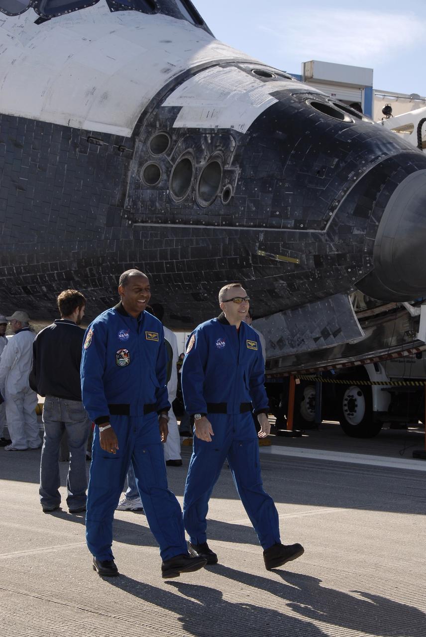CAPE CANAVERAL, Fla. - At the Shuttle Landing Facility at NASA's Kennedy Space Center in Florida, STS-129 Mission Specialists Robert L. Satcher Jr., left, and Randy Bresnik appear to march in cadence as they join their fellow crewmates for an appearance on NASA Television.  Space shuttle Atlantis landed on Runway 33, completing the 4.5-million mile STS-129 mission to the International Space Station on orbit 171.  Main gear touchdown was at 9:44:23 a.m. EST. Nose gear touchdown was at 9:44:36 a.m., and wheels stop was at 9:45:05 a.m.   Expedition 20 and 21 Flight Engineer Nicole Stott, who spent 87 days aboard the International Space Station, also returned on Atlantis.  STS-129 is the final space shuttle Expedition crew rotation flight on the manifest.  On STS-129, the crew delivered 14 tons of cargo to the orbiting laboratory, including two ExPRESS Logistics Carriers containing spare parts to sustain station operations after the shuttles are retired next year.  For information on the STS-129 mission and crew, visit http://www.nasa.gov/mission_pages/shuttle/shuttlemissions/sts129/index.html.    Photo credit: NASA/Kim Shiflett