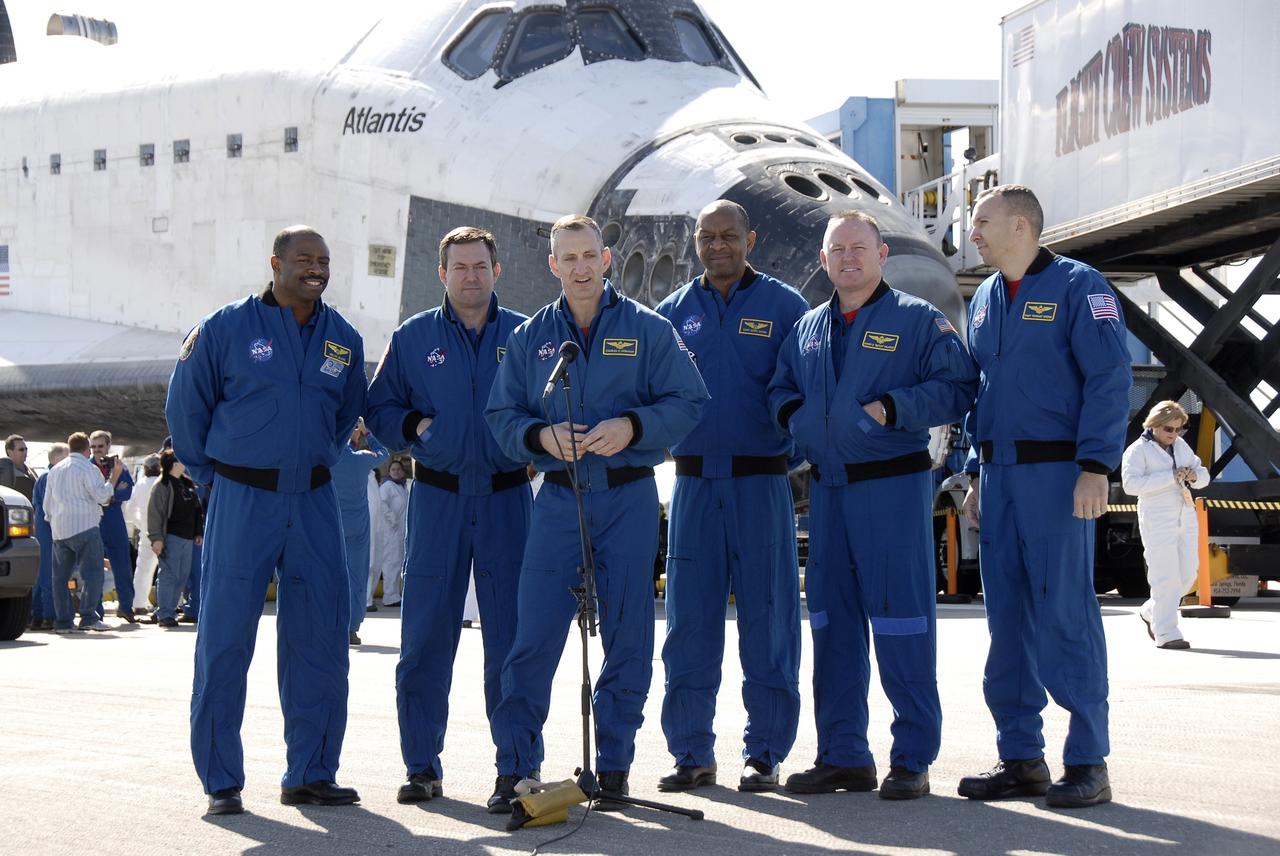 CAPE CANAVERAL, Fla. - At the Shuttle Landing Facility at NASA's Kennedy Space Center in Florida, STS-129 Commander Charles O. Hobaugh comments on his successful mission for NASA Television.  From left are Mission Specialists Leland Melvin and Mike Foreman; Hobaugh, at microphone; Mission Specialist Robert L. Satcher Jr.; Pilot Barry E. Wilmore; and Mission Specialist Randy Bresnik.  Space shuttle Atlantis landed on Runway 33, completing the 4.5-million mile STS-129 mission to the International Space Station on orbit 171.  Main gear touchdown was at 9:44:23 a.m. EST. Nose gear touchdown was at 9:44:36 a.m., and wheels stop was at 9:45:05 a.m.   Expedition 20 and 21 Flight Engineer Nicole Stott, who spent 87 days aboard the station, also returned on Atlantis.  STS-129 is the final space shuttle Expedition crew rotation flight on the manifest.  On STS-129, the crew delivered 14 tons of cargo to the orbiting laboratory, including two ExPRESS Logistics Carriers containing spare parts to sustain station operations after the shuttles are retired next year.  For information on the STS-129 mission and crew, visit http://www.nasa.gov/mission_pages/shuttle/shuttlemissions/sts129/index.html.     Photo credit: NASA/Kim Shiflett