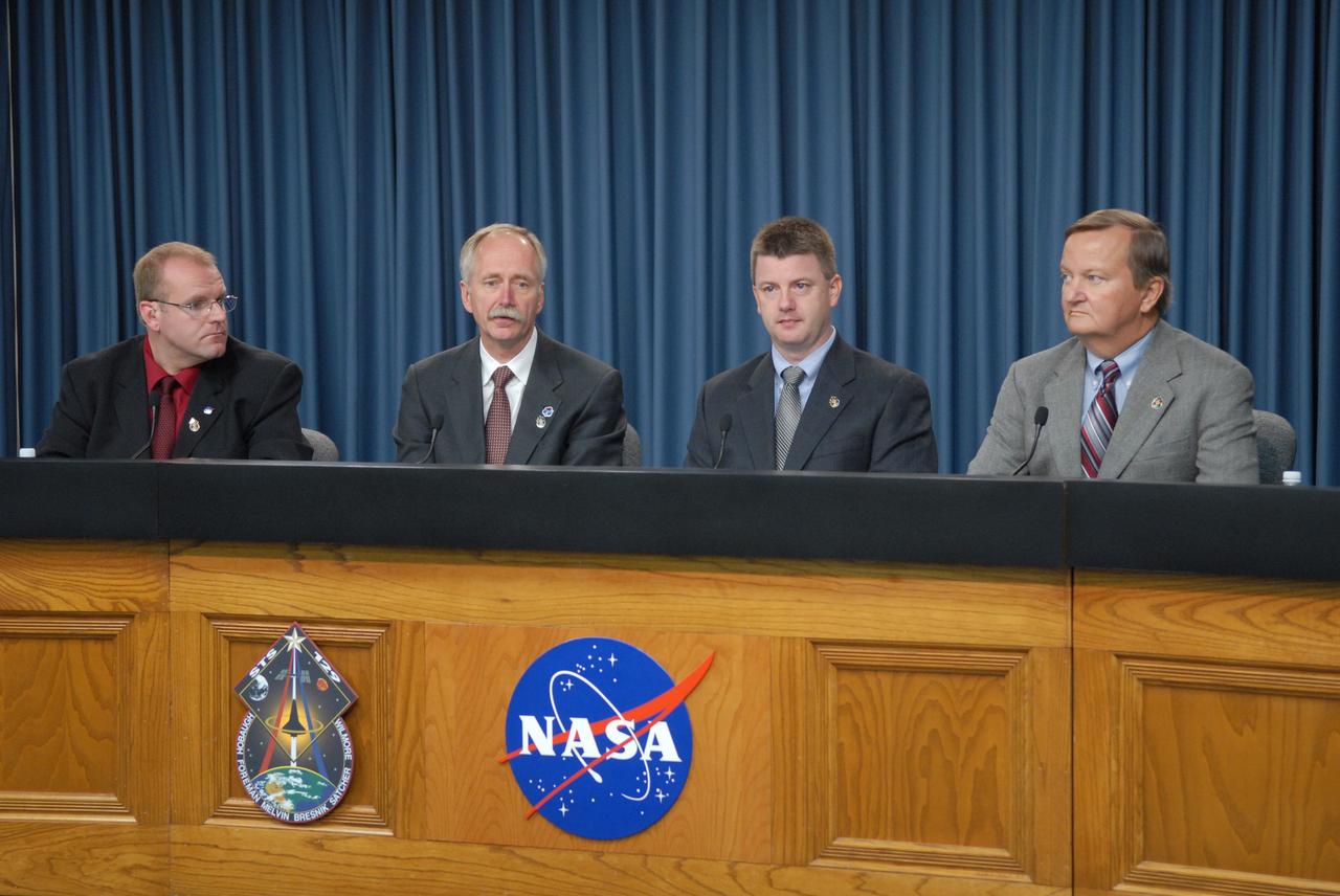 CAPE CANAVERAL, Fla. - A post-landing news conference is held in the NASA Press Site auditorium at NASA's Kennedy Space Center in Florida after the picture-perfect landing of space shuttle Atlantis concluding the STS-129 mission. From left are NASA Public Affairs moderator Allard Beutel; Bill Gerstenmaier, associate administrator for Space Operations; Mike Moses, chair, Mission Management Team; and Mike Leinbach, space shuttle launch director.    Main gear touchdown at Kennedy's Shuttle Landing Facility was at 9:44:23 a.m. EST. Nose gear touchdown was at 9:44:36 a.m., and wheels stop was at 9:45:05 a.m.  Returning aboard Atlantis were STS-129 Commander Charles O. Hobaugh; Pilot Barry E. Wilmore; Mission Specialists Leland Melvin, Randy Bresnik, Mike Foreman and Robert L. Satcher Jr.; and Expedition 20 and 21 Flight Engineer Nicole Stott who spent 87 days aboard the International Space Station.  STS-129 is the final space shuttle Expedition crew rotation flight on the manifest.  On STS-129, the crew delivered 14 tons of cargo to the orbiting laboratory, including two ExPRESS Logistics Carriers containing spare parts to sustain station operations after the shuttles are retired next year.  For information on the STS-129 mission and crew, visit http://www.nasa.gov/mission_pages/shuttle/shuttlemissions/sts129/index.html.    Photo credit: NASA/Jim Grossmann