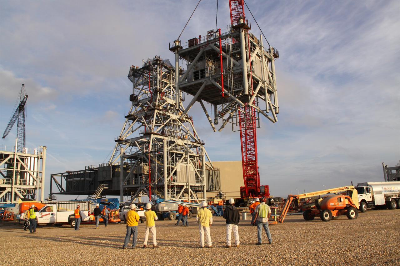 CAPE CANAVERAL, Fla. – At NASA's Kennedy Space Center in Florida, workers monitor the lift of the fifth segment of the tower of a new mobile launcher, or ML, being constructed to support the Constellation Program. When completed, the tower will be approximately 345 feet tall and have multiple platforms for personnel access. The construction is under way at the mobile launcher park site area north of Kennedy's Vehicle Assembly Building. The launcher will provide a base to launch the Ares I rocket, designed to transport the Orion crew exploration vehicle, its crew and cargo to low Earth orbit. Its base is being made lighter than space shuttle mobile launcher platforms so the crawler-transporter can pick up the heavier load of the tower and taller rocket. For information on the Ares I, visit http://www.nasa.gov/ares. Photo credit: NASA/Jack Pfaller