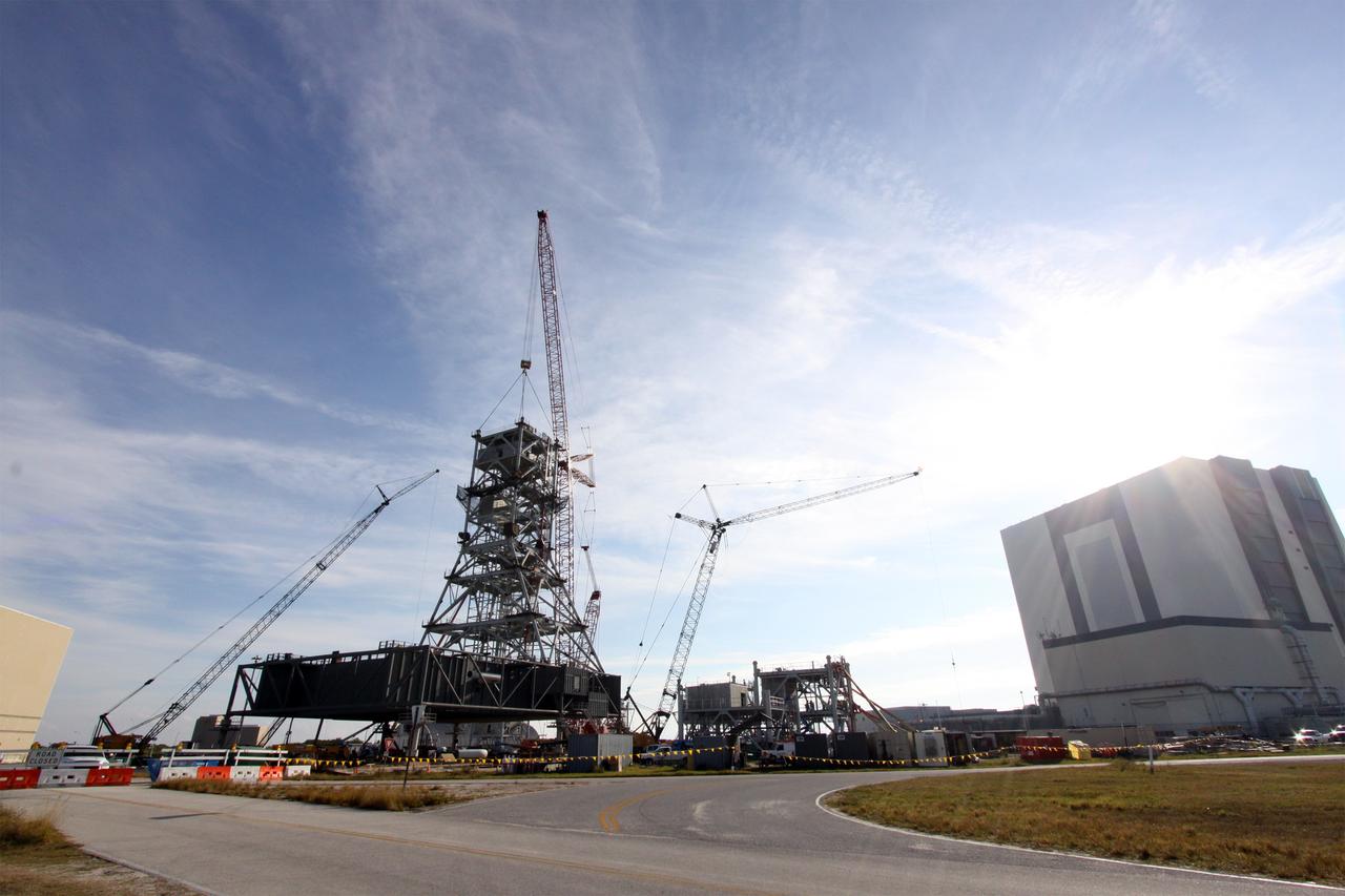 CAPE CANAVERAL, Fla. – At the mobile launcher park site area north of the Vehicle Assembly Building at NASA's Kennedy Space Center in Florida, progress on the construction of a new mobile launcher, or ML, to support the Constellation Program is apparent. When completed, the launcher's tower will be approximately 345 feet tall and have multiple platforms for personnel access. The launcher will provide a base to launch the Ares I rocket, designed to transport the Orion crew exploration vehicle, its crew and cargo to low Earth orbit. Its base is being made lighter than space shuttle mobile launcher platforms so the crawler-transporter can pick up the heavier load of the tower and taller rocket. For information on the Ares I, visit http://www.nasa.gov/ares. Photo credit: NASA/Jack Pfaller