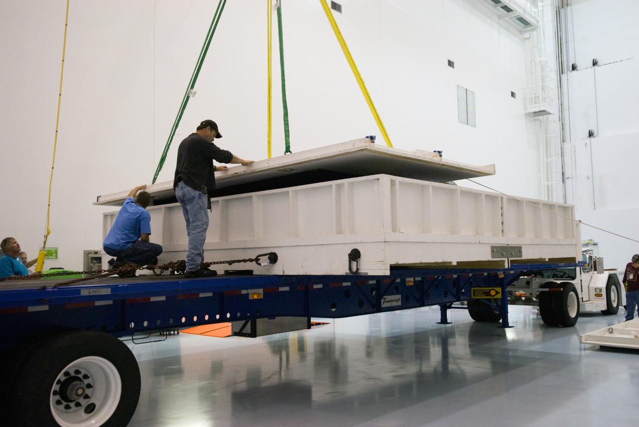 CAPE CANAVERAL, Fla. - In the Space Station Processing Facility at NASA's Kennedy Space Center in Florida, a crane lifts the cover from the transportation case protecting the ExPRESS Logistics Carrier 3, or ELC-3. ELC-3 and the Alpha Magnetic Spectrometer are the primary payloads for space shuttle Endeavour's STS-134 mission to the International Space Station. The STS-134 crew will also deliver spare parts including two S-band communications antennas, a high pressure gas tank, additional spare parts for Dextre and micrometeoroid debris shields. Endeavour's launch is targeted for July 29, 2010. For information on the STS-134 mission objectives and crew, visit http://www.nasa.gov/shuttle. Photo credit: NASA/Kim Shiflett