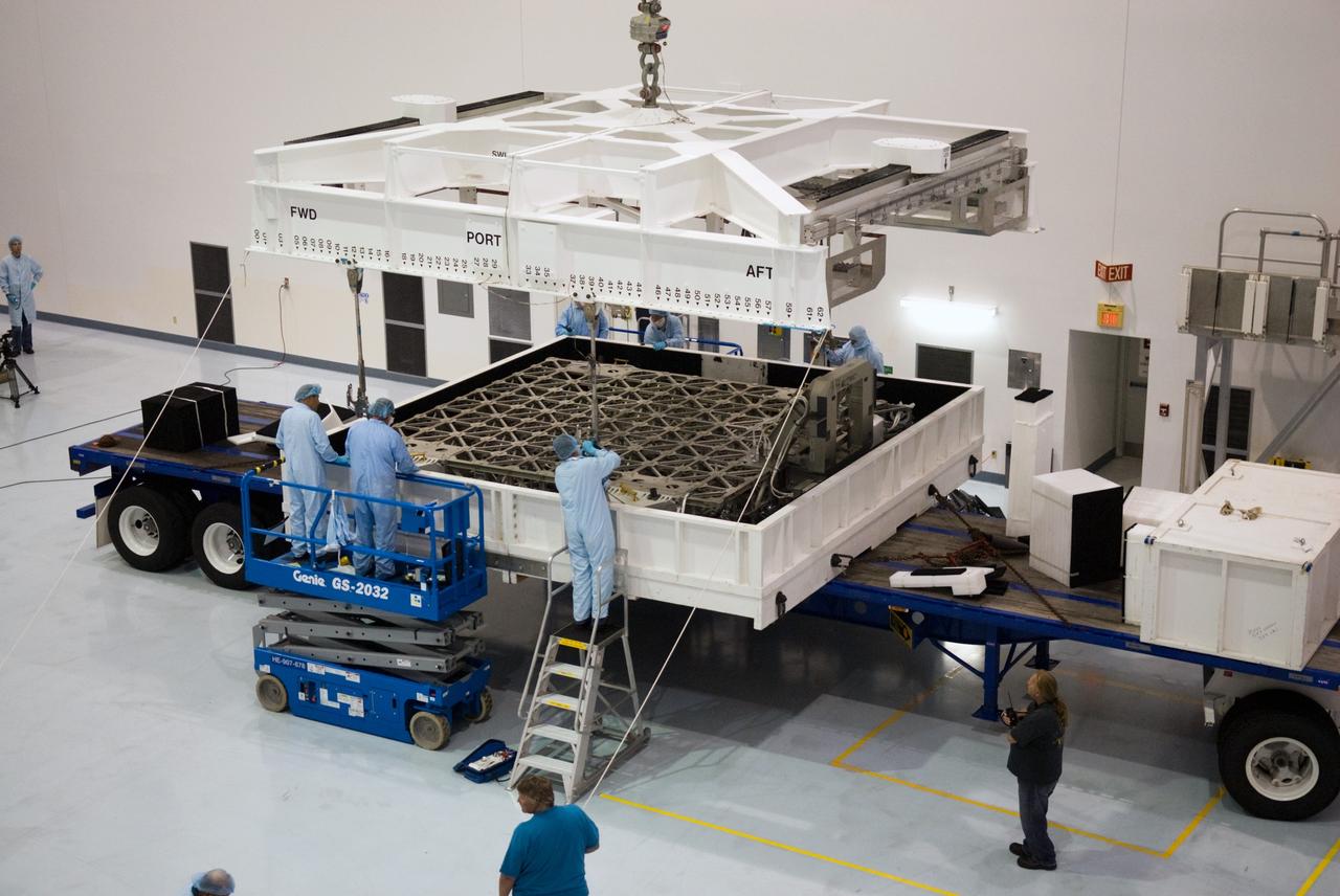 CAPE CANAVERAL, Fla. - In the Space Station Processing Facility at NASA's Kennedy Space Center in Florida, workers attach a crane to the ExPRESS Logistics Carrier 3, or ELC-3, in preparations to lift it from its transportation case. ELC-3 and the Alpha Magnetic Spectrometer are the primary payloads for space shuttle Endeavour's STS-134 mission to the International Space Station. The STS-134 crew will also deliver spare parts including two S-band communications antennas, a high pressure gas tank, additional spare parts for Dextre and micrometeoroid debris shields. Endeavour's launch is targeted for July 29, 2010. For information on the STS-134 mission objectives and crew, visit http://www.nasa.gov/shuttle. Photo credit: NASA/Kim Shiflett