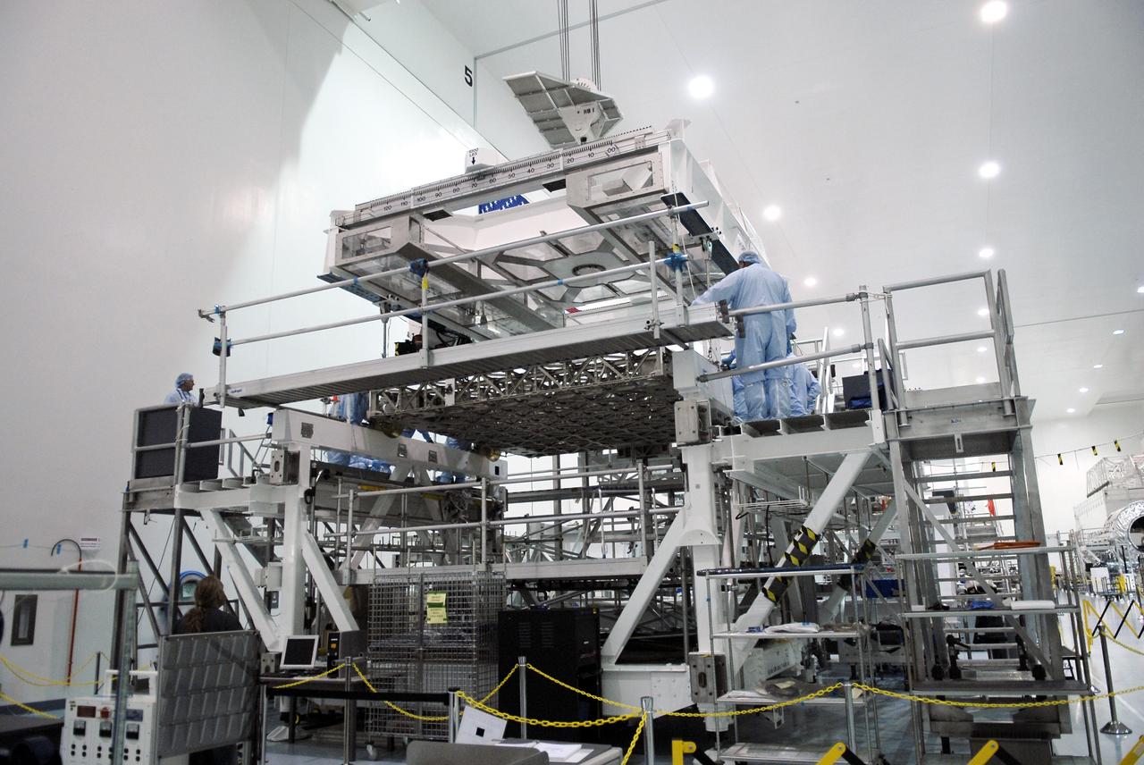 CAPE CANAVERAL, Fla. - In the Space Station Processing Facility at NASA's Kennedy Space Center in Florida, workers secure the newly arrived ExPRESS Logistics Carrier 3, or ELC-3, on its work stand in the clean room. ELC-3 and the Alpha Magnetic Spectrometer are the primary payloads for space shuttle Endeavour's STS-134 mission to the International Space Station. The STS-134 crew will also deliver spare parts including two S-band communications antennas, a high pressure gas tank, additional spare parts for Dextre and micrometeoroid debris shields. Endeavour's launch is targeted for July 29, 2010. For information on the STS-134 mission objectives and crew, visit http://www.nasa.gov/shuttle. Photo credit: NASA/Kim Shiflett