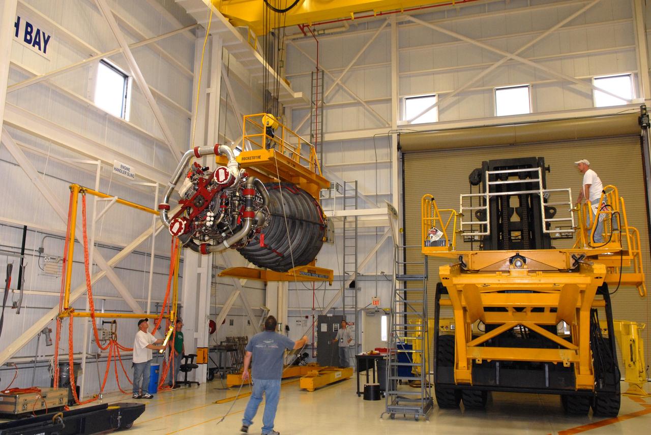 CAPE CANAVERAL, Fla. - In the Space Shuttle Main Engine Processing Facility at NASA's Kennedy Space Center in Florida, United Space Alliance workers lift a main engine toward a transporter. The engine is being moved to Orbiter Processing Facility Bay 3 where it will be installed in space shuttle Discovery during processing for the shuttle's STS-131 mission to the International Space Station. The seven-member STS-131 crew will deliver a Multi-Purpose Logistics Module filled with resupply stowage platforms and racks to be transferred to locations around the station. Three spacewalks will include work to attach a spare ammonia tank assembly to the station's exterior and return a European experiment from outside the station's Columbus module. Discovery's launch, targeted for March 18, 2010, will initiate the 33rd shuttle mission to the station. For information on the STS-131 mission and crew, visit http://www.nasa.gov/mission_pages/shuttle/shuttlemissions/sts131/index.html. Photo credit: NASA/Jim Grossmann
