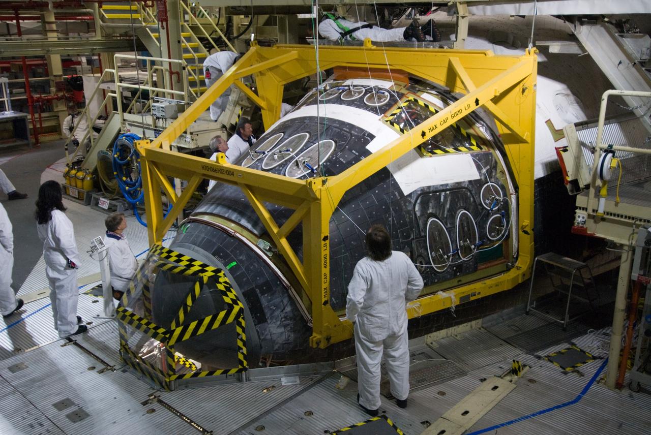 CAPE CANAVERAL, Fla. - In Orbiter Processing Facility Bay 3 at NASA's Kennedy Space Center in Florida, space shuttle Discovery's Forward Reaction Control System, or FRCS, has been returned to its proper place on the shuttle's frame. The FRCS is being reinstalled in the forward fuselage nose area of the shuttle after refurbishment. The FRCS provides the thrust for attitude (rotational) maneuvers (pitch, yaw and roll) and for small velocity changes along the orbiter axis (translation maneuvers). Discovery is being prepared for the STS-131 mission, the 33rd flight to the International Space Station. The seven-member STS-131 crew will deliver a Multi-Purpose Logistics Module filled with resupply stowage platforms and racks to be transferred to locations around the station. Three spacewalks will include work to attach a spare ammonia tank assembly to the station's exterior and return a European experiment from outside the station's Columbus module. Discovery's launch is targeted for March 18, 2010. For information on the STS-131 mission and crew, visit http://www.nasa.gov/mission_pages/shuttle/shuttlemissions/sts131/index.html. Photo credit: NASA/Amanda Diller