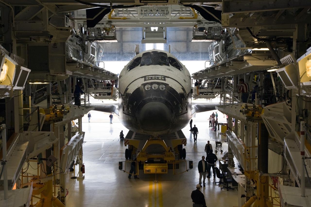CAPE CANAVERAL, Fla. – In Orbiter Processing Facility-2 at NASA's Kennedy Space Center in Florida, work platforms are removed from around space shuttle Endeavour in preparation for its roll to the Vehicle Assembly Building. The rollover began at 12:53 a.m. EST and was completed at 2:08 p.m. when Endeavour was towed into the VAB's transfer aisle. Next, Endeavour will be attached to a lifting sling, hoisted over a transom and lowered into High Bay 1, where it will be attached to its external fuel tank and solid rocket boosters. Rollout of the shuttle stack to Kennedy’s Launch Pad 39A, a significant milestone in launch processing activities, is planned for early January 2010. The Italian-built Tranquility module, the primary payload for Endeavour's STS-130 mission, will be installed in the payload bay after the shuttle arrives at the pad. Launch is targeted for early February. For information on the STS-130 mission and crew, visit http://www.nasa.gov/mission_pages/shuttle/shuttlemissions/sts130/index.html. Photo credit: NASA/Dimitri Gerondidakis