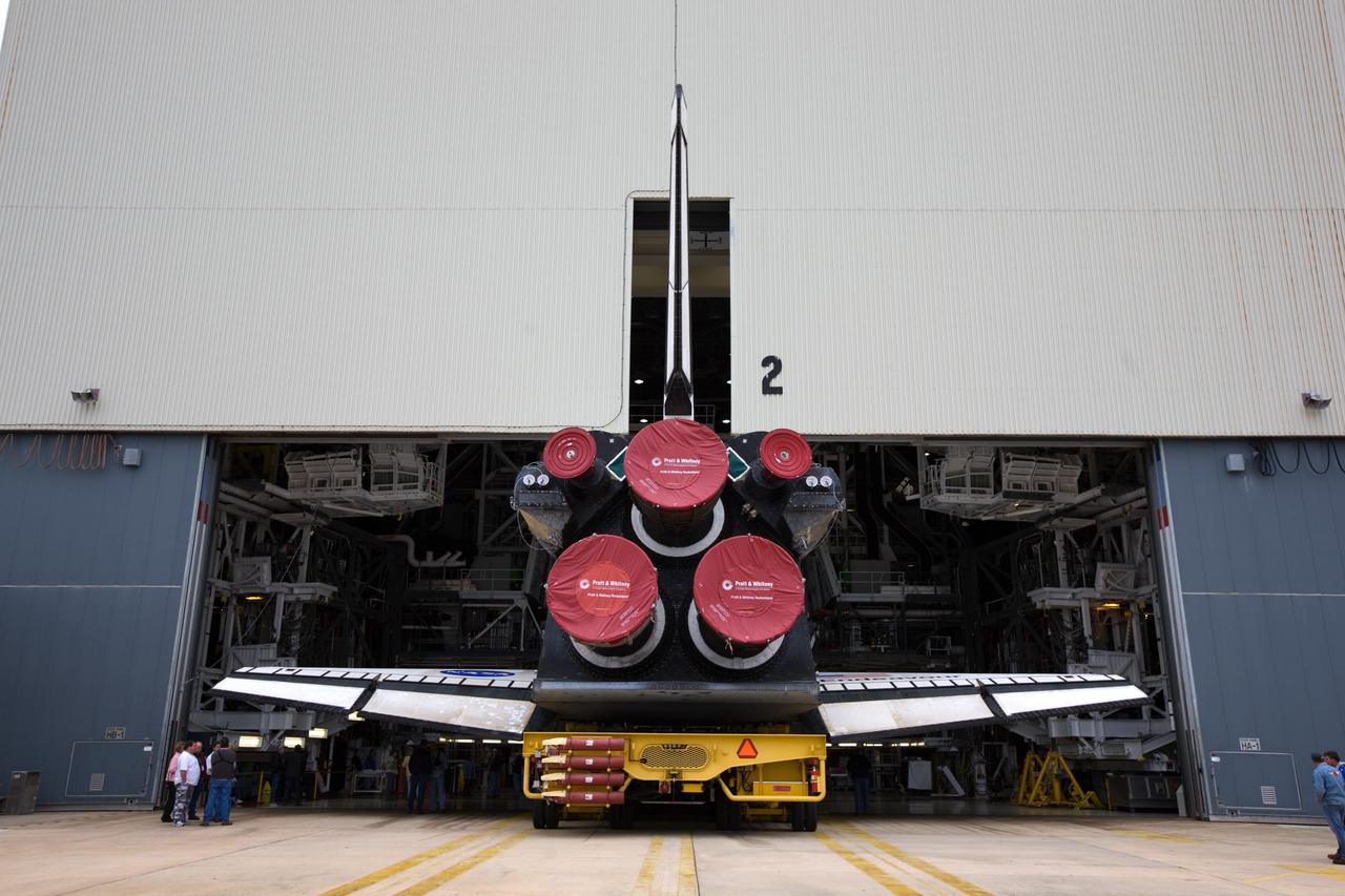 CAPE CANAVERAL, Fla. – At NASA's Kennedy Space Center in Florida, space shuttle Endeavour slowly backs out of Orbiter Processing Facility-2 to begin its roll to the Vehicle Assembly Building. The rollover began at 12:53 a.m. EST and was completed at 2:08 p.m. when Endeavour was towed into the VAB's transfer aisle. Next, Endeavour will be attached to a lifting sling, hoisted over a transom and lowered into High Bay 1, where it will be attached to its external fuel tank and solid rocket boosters. Rollout of the shuttle stack to Kennedy’s Launch Pad 39A, a significant milestone in launch processing activities, is planned for early January 2010. The Italian-built Tranquility module, the primary payload for Endeavour's STS-130 mission, will be installed in the payload bay after the shuttle arrives at the pad. Launch is targeted for early February. For information on the STS-130 mission and crew, visit http://www.nasa.gov/mission_pages/shuttle/shuttlemissions/sts130/index.html. Photo credit: NASA/Dimitri Gerondidakis