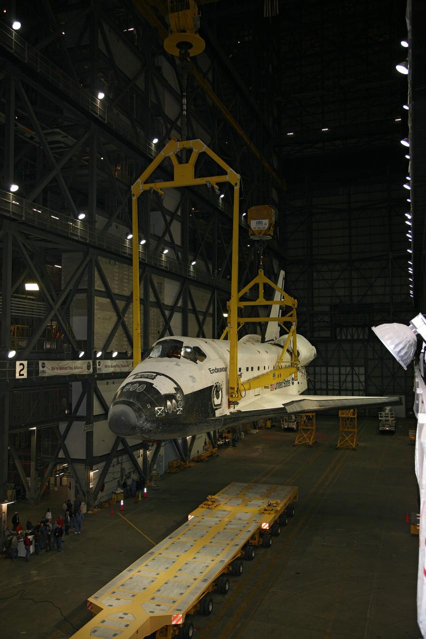 CAPE CANAVERAL, Fla. – In the transfer aisle of the Vehicle Assembly Building at NASA's Kennedy Space Center in Florida, space shuttle Endeavour is lifted from its transporter by a sling. Next, Endeavour will be hoisted over a transom and lowered into High Bay 1, where it will be attached to its external fuel tank and solid rocket boosters. Rollout of the shuttle stack to Kennedy’s Launch Pad 39A, a significant milestone in launch processing activities, is planned for early January 2010. The Italian-built Tranquility module, the primary payload for Endeavour's STS-130 mission, will be installed in the payload bay after the shuttle arrives at the pad. Launch is targeted for early February. For information on the STS-130 mission and crew, visit http://www.nasa.gov/mission_pages/shuttle/shuttlemissions/sts130/index.html. Photo credit: NASA/Dimitri Gerondidakis