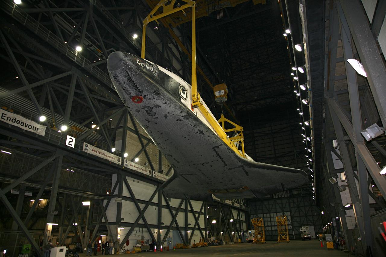 CAPE CANAVERAL, Fla. – In the transfer aisle of the Vehicle Assembly Building at NASA's Kennedy Space Center in Florida, space shuttle Endeavour, attached to the yellow framework of a sling, is lifted from its transporter. Next, Endeavour will be hoisted over a transom and lowered into High Bay 1, where it will be attached to its external fuel tank and solid rocket boosters. Rollout of the shuttle stack to Kennedy’s Launch Pad 39A, a significant milestone in launch processing activities, is planned for early January 2010. The Italian-built Tranquility module, the primary payload for Endeavour's STS-130 mission, will be installed in the payload bay after the shuttle arrives at the pad. Launch is targeted for early February. For information on the STS-130 mission and crew, visit http://www.nasa.gov/mission_pages/shuttle/shuttlemissions/sts130/index.html. Photo credit: NASA/Dimitri Gerondidakis