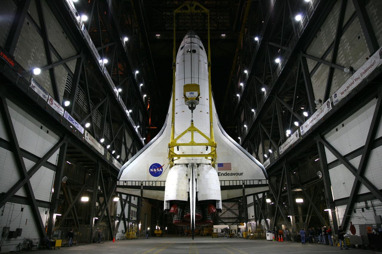 CAPE CANAVERAL, Fla. – In the transfer aisle of the Vehicle Assembly Building at NASA's Kennedy Space Center in Florida, space shuttle Endeavour, attached to the yellow framework of a sling, hovers over the transfer aisle in a vertical position. Next, Endeavour will be hoisted over a transom and lowered into High Bay 1, where it will be attached to its external fuel tank and solid rocket boosters. Rollout of the shuttle stack to Kennedy’s Launch Pad 39A, a significant milestone in launch processing activities, is planned for early January 2010. The Italian-built Tranquility module, the primary payload for Endeavour's STS-130 mission, will be installed in the payload bay after the shuttle arrives at the pad. Launch is targeted for early February. For information on the STS-130 mission and crew, visit http://www.nasa.gov/mission_pages/shuttle/shuttlemissions/sts130/index.html. Photo credit: NASA/Dimitri Gerondidakis