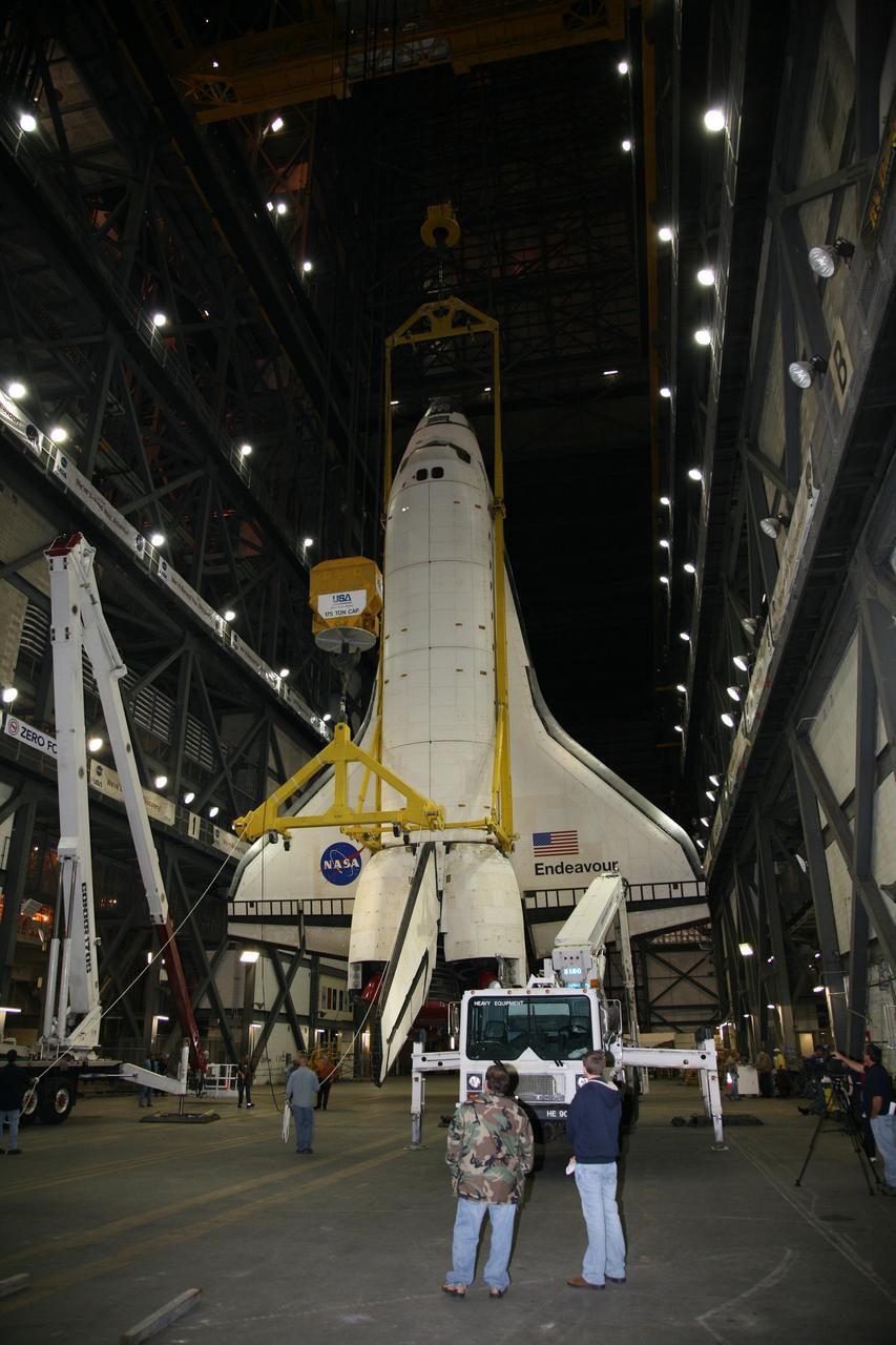 CAPE CANAVERAL, Fla. – In the transfer aisle of the Vehicle Assembly Building at NASA's Kennedy Space Center in Florida, United Space Alliance technicians prepare to steady space shuttle Endeavour as it is lifted. Next, Endeavour will be hoisted over a transom and lowered into High Bay 1, where it will be attached to its external fuel tank and solid rocket boosters. Rollout of the shuttle stack to Kennedy’s Launch Pad 39A, a significant milestone in launch processing activities, is planned for early January 2010. The Italian-built Tranquility module, the primary payload for Endeavour's STS-130 mission, will be installed in the payload bay after the shuttle arrives at the pad. Launch is targeted for early February. For information on the STS-130 mission and crew, visit http://www.nasa.gov/mission_pages/shuttle/shuttlemissions/sts130/index.html. Photo credit: NASA/Dimitri Gerondidakis