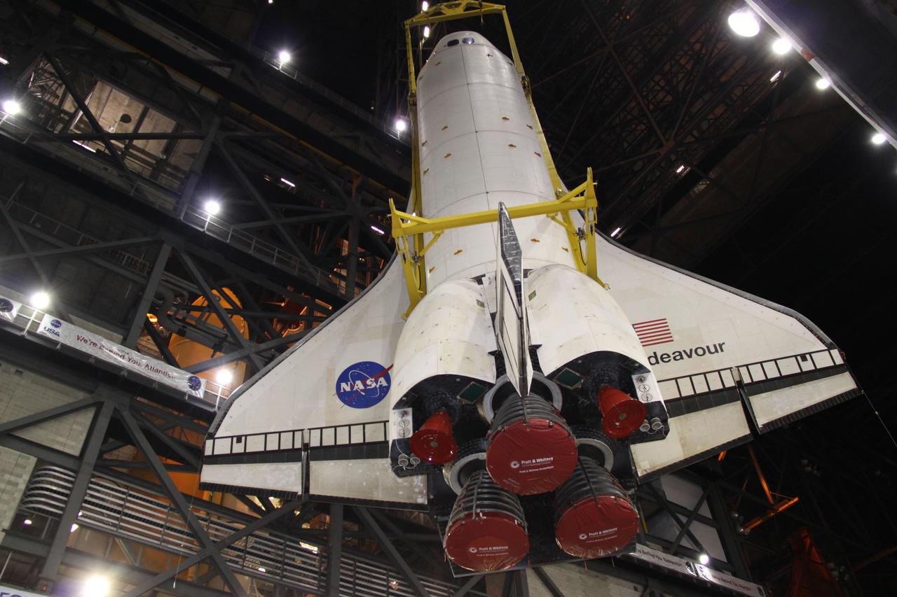 CAPE CANAVERAL, Fla. – In the transfer aisle of the Vehicle Assembly Building at NASA's Kennedy Space Center in Florida, space shuttle Endeavour, rotated into a vertical position with the aid of a sling, is lifted toward the ceiling. Next, Endeavour will be hoisted over a transom and lowered into High Bay 1, where it will be attached to its external fuel tank and solid rocket boosters. Rollout of the shuttle stack to Kennedy’s Launch Pad 39A, a significant milestone in launch processing activities, is planned for early January 2010. The Italian-built Tranquility module, the primary payload for Endeavour's STS-130 mission, will be installed in the payload bay after the shuttle arrives at the pad. Launch is targeted for early February. For information on the STS-130 mission and crew, visit http://www.nasa.gov/mission_pages/shuttle/shuttlemissions/sts130/index.html. Photo credit: NASA/Jack Pfaller