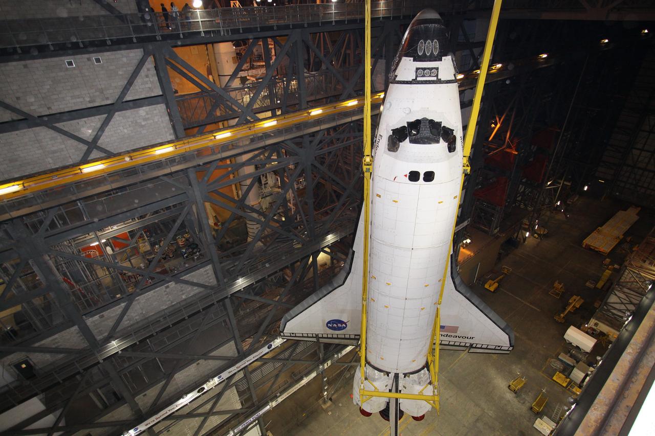 CAPE CANAVERAL, Fla. – In the transfer aisle of the Vehicle Assembly Building at NASA's Kennedy Space Center in Florida, space shuttle Endeavour, rotated into a vertical position with the aid of a sling, is lifted high above the floor. Next, Endeavour will be hoisted over a transom and lowered into High Bay 1, where it will be attached to its external fuel tank and solid rocket boosters. Rollout of the shuttle stack to Kennedy’s Launch Pad 39A, a significant milestone in launch processing activities, is planned for early January 2010. The Italian-built Tranquility module, the primary payload for Endeavour's STS-130 mission, will be installed in the payload bay after the shuttle arrives at the pad. Launch is targeted for early February. For information on the STS-130 mission and crew, visit http://www.nasa.gov/mission_pages/shuttle/shuttlemissions/sts130/index.html. Photo credit: NASA/Jack Pfaller