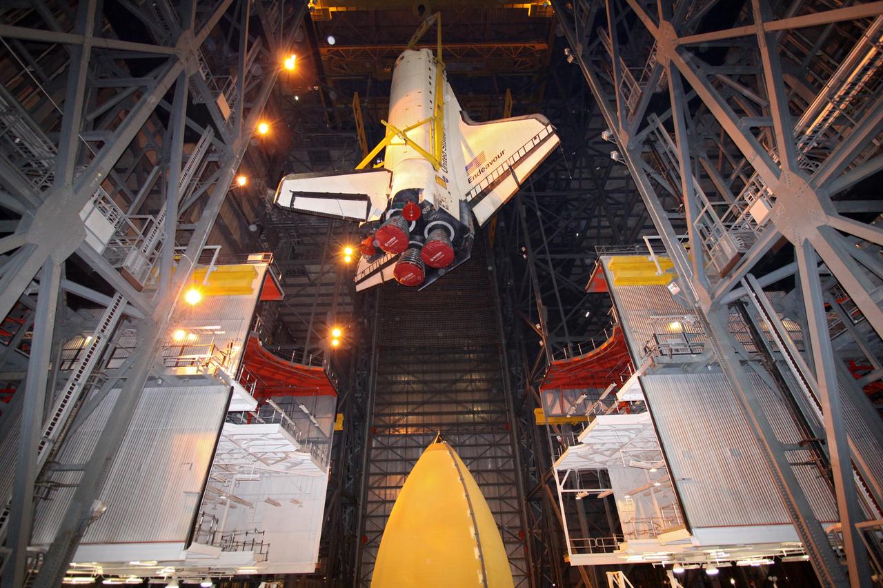 CAPE CANAVERAL, Fla. – In High Bay 1 in the Vehicle Assembly Building at NASA's Kennedy Space Center in Florida, a crane lowers space shuttle Endeavour toward the external fuel tank and solid rocket boosters to which it will be attached. Rollout of the shuttle stack to Kennedy’s Launch Pad 39A, a significant milestone in launch processing activities, is planned for early January 2010. The Italian-built Tranquility module, the primary payload for Endeavour's STS-130 mission, will be installed in the payload bay after the shuttle arrives at the pad. Launch is targeted for early February. For information on the STS-130 mission and crew, visit http://www.nasa.gov/mission_pages/shuttle/shuttlemissions/sts130/index.html. Photo credit: NASA/Jack Pfaller