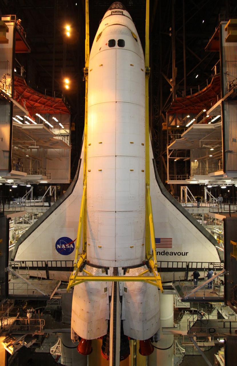 CAPE CANAVERAL, Fla. – In the Vehicle Assembly Building at NASA's Kennedy Space Center in Florida, the work platforms in High Bay 1 frame space shuttle Endeavour as a crane lowers it alongside the external fuel tank and solid rocket boosters to which it will be attached. Rollout of the shuttle stack to Kennedy’s Launch Pad 39A, a significant milestone in launch processing activities, is planned for early January 2010. The Italian-built Tranquility module, the primary payload for Endeavour's STS-130 mission, will be installed in the payload bay after the shuttle arrives at the pad. Launch is targeted for early February. For information on the STS-130 mission and crew, visit http://www.nasa.gov/mission_pages/shuttle/shuttlemissions/sts130/index.html. Photo credit: NASA/Jack Pfaller