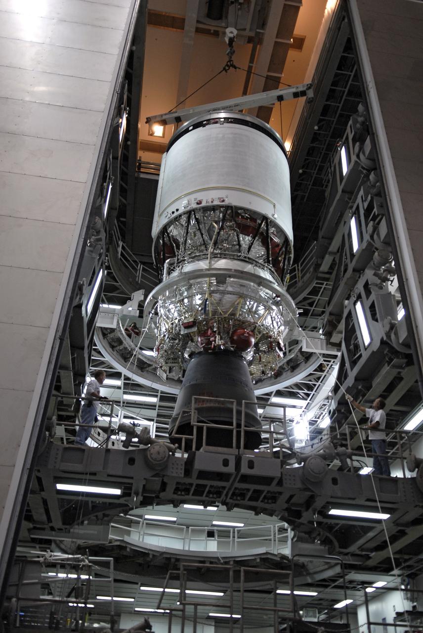 CAPE CANAVERAL, Fla. – Workers prepare to lower the second stage of a Delta IV rocket from a test cell in the hangar of the Delta Operations Center at Cape Canaveral Air Force Station in Florida into a turnover stand following the completion of nozzle extension deployment system testing. The United Launch Alliance Delta IV rocket is slated to launch GOES-P, the latest Geostationary Operational Environmental Satellite developed by NASA for the National Oceanic and Atmospheric Administration, or NOAA. Next, the second stage will be transported to the Horizontal Integration Facility where it will be inspected and prepared for mating with the Delta IV rocket's first stage. GOES-P, a meteorological satellite, is designed to watch for storm development and observed current weather conditions on Earth. Launch of GOES-P is scheduled for no earlier than Feb. 25, 2010, from Launch Complex 37. For information on GOES-P, visit http://goespoes.gsfc.nasa.gov/goes/spacecraft/n_p_spacecraft.html. Photo credit: NASA/Glenn Benson