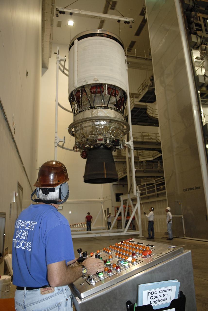 CAPE CANAVERAL, Fla. – Workers move the second stage of a Delta IV rocket from a test cell in the hangar of the Delta Operations Center at Cape Canaveral Air Force Station in Florida into a turnover stand following the completion of nozzle extension deployment system testing. The United Launch Alliance Delta IV rocket is slated to launch GOES-P, the latest Geostationary Operational Environmental Satellite developed by NASA for the National Oceanic and Atmospheric Administration, or NOAA. Next, the second stage will be transported to the Horizontal Integration Facility where it will be inspected and prepared for mating with the Delta IV rocket's first stage. GOES-P, a meteorological satellite, is designed to watch for storm development and observed current weather conditions on Earth. Launch of GOES-P is scheduled for no earlier than Feb. 25, 2010, from Launch Complex 37. For information on GOES-P, visit http://goespoes.gsfc.nasa.gov/goes/spacecraft/n_p_spacecraft.html. Photo credit: NASA/Glenn Benson