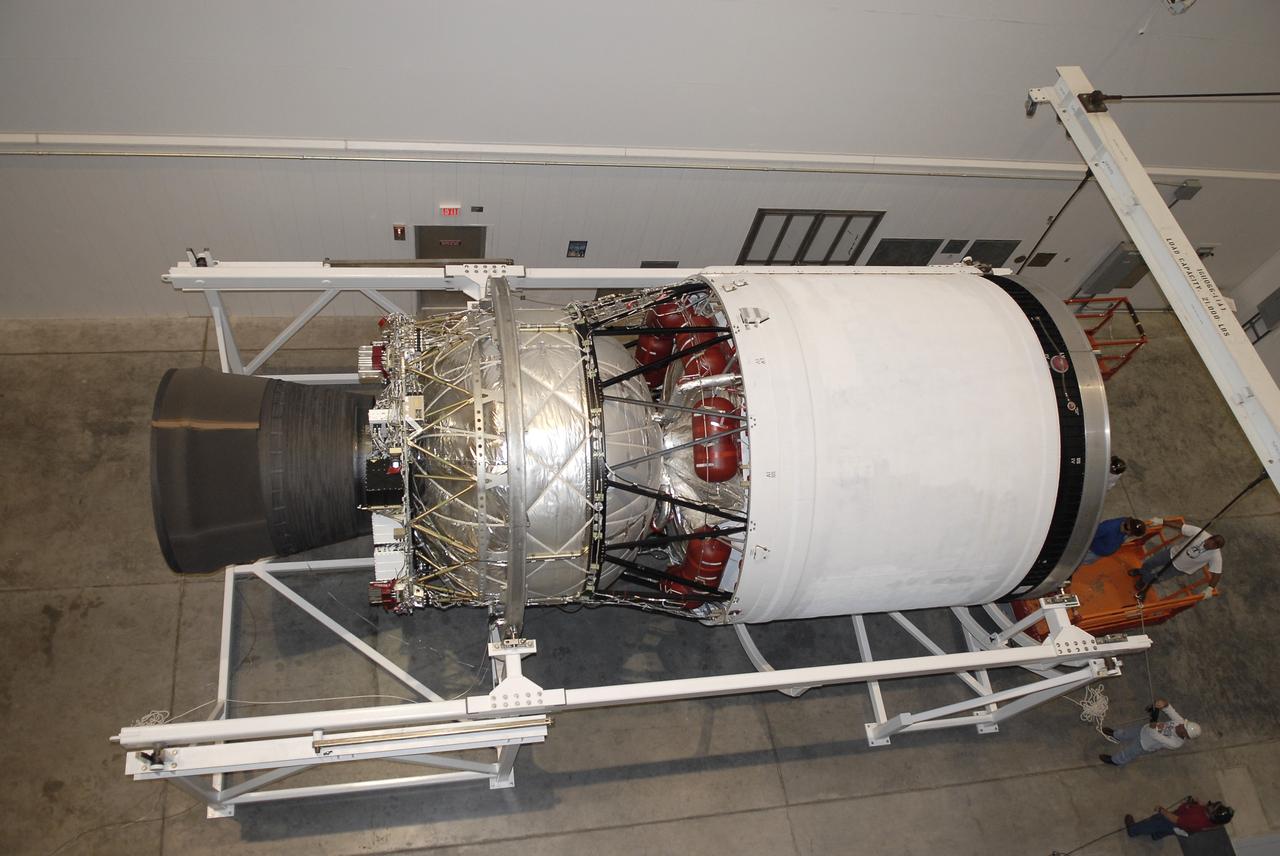 CAPE CANAVERAL, Fla. – In the hangar of the Delta Operations Center at Cape Canaveral Air Force Station in Florida, the second stage of a Delta IV rocket has been rotated to a horizontal position with the aid of a turnover stand following the completion of nozzle extension deployment system testing in the hangar's test cell.    The United Launch Alliance Delta IV rocket is slated to launch GOES-P, the latest Geostationary Operational Environmental Satellite developed by NASA for the National Oceanic and Atmospheric Administration, or NOAA. Next, the second stage will be transported to the Horizontal Integration Facility where it will be inspected and prepared for mating with the Delta IV rocket's first stage.  GOES-P, a meteorological satellite, is designed to watch for storm development and observed current weather conditions on Earth.  Launch of GOES-P is scheduled for no earlier than Feb. 25, 2010, from Launch Complex 37.  For information on GOES-P, visit http://goespoes.gsfc.nasa.gov/goes/spacecraft/n_p_spacecraft.html. Photo credit: NASA/Glenn Benson