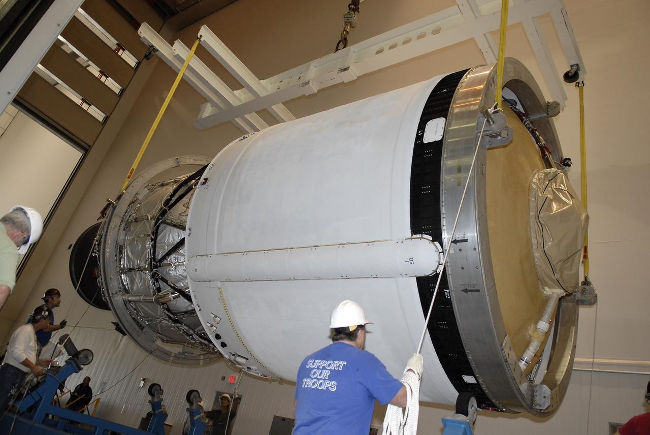 CAPE CANAVERAL, Fla. – In the hangar of the Delta Operations Center at Cape Canaveral Air Force Station in Florida, workers lower the second stage of a Delta IV rocket onto a transporter following the completion of nozzle extension deployment system testing in the hangar's test cell. The United Launch Alliance Delta IV rocket is slated to launch GOES-P, the latest Geostationary Operational Environmental Satellite developed by NASA for the National Oceanic and Atmospheric Administration, or NOAA. Next, the second stage will be transported to the Horizontal Integration Facility where it will be inspected and prepared for mating with the Delta IV rocket's first stage. GOES-P, a meteorological satellite, is designed to watch for storm development and observed current weather conditions on Earth. Launch of GOES-P is scheduled for no earlier than Feb. 25, 2010, from Launch Complex 37. For information on GOES-P, visit http://goespoes.gsfc.nasa.gov/goes/spacecraft/n_p_spacecraft.html. Photo credit: NASA/Glenn Benson
