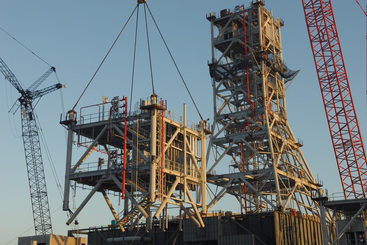 CAPE CANAVERAL, Fla. – At NASA's Kennedy Space Center in Florida, the sixth tower segment is lifted toward five segments already secured to a new mobile launcher, or ML, being constructed to support the Constellation Program. When completed, the tower will be approximately 345 feet tall and have multiple platforms for personnel access. The construction is under way at the mobile launcher park site area north of Kennedy's Vehicle Assembly Building. The launcher will provide a base to launch the Ares I rocket, designed to transport the Orion crew exploration vehicle, its crew and cargo to low Earth orbit. Its base is being made lighter than space shuttle mobile launcher platforms so the crawler-transporter can pick up the heavier load of the tower and taller rocket. For information on the Ares I, visit http://www.nasa.gov/ares. Photo credit: NASA/Jim Grossmann