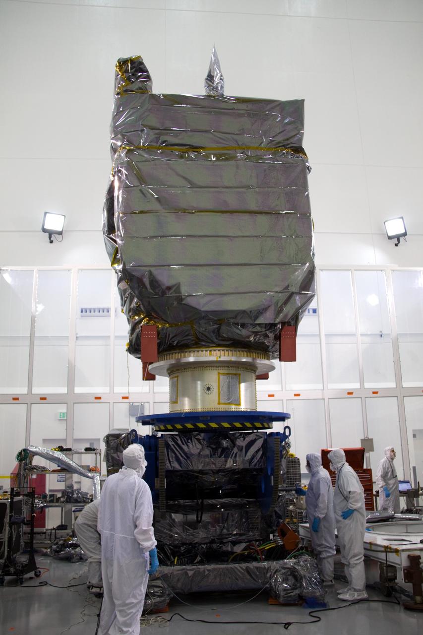 CAPE CANAVERAL, Fla. – At the Astrotech Space Operations facility in Titusville, Fla., technicians from NASA's Goddard Space Flight Center rotate the bagged Solar Dynamics Observatory, or SDO, secured to a Ransome table, into a vertical position.    SDO is the first space weather research network mission in NASA's Living With a Star Program. The spacecraft's long-term measurements will give solar scientists in-depth information about changes in the sun's magnetic field and insight into how they affect Earth. Liftoff on an Atlas V rocket is scheduled for Feb. 3, 2010. For information on SDO, visit http://www.nasa.gov/sdo.  Photo credit: NASA/Troy Cryder