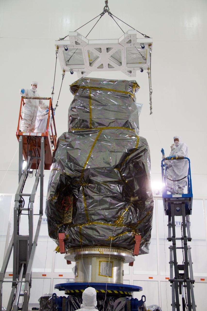 CAPE CANAVERAL, Fla. – At the Astrotech Space Operations facility in Titusville, Fla., technicians from NASA's Goddard Space Flight Center attach a lifting device to the bagged Solar Dynamics Observatory, or SDO, during preparations to remove it from a Ransome table.    SDO is the first space weather research network mission in NASA's Living With a Star Program. The spacecraft's long-term measurements will give solar scientists in-depth information about changes in the sun's magnetic field and insight into how they affect Earth. Liftoff on an Atlas V rocket is scheduled for Feb. 3, 2010. For information on SDO, visit http://www.nasa.gov/sdo.  Photo credit: NASA/Troy Cryder
