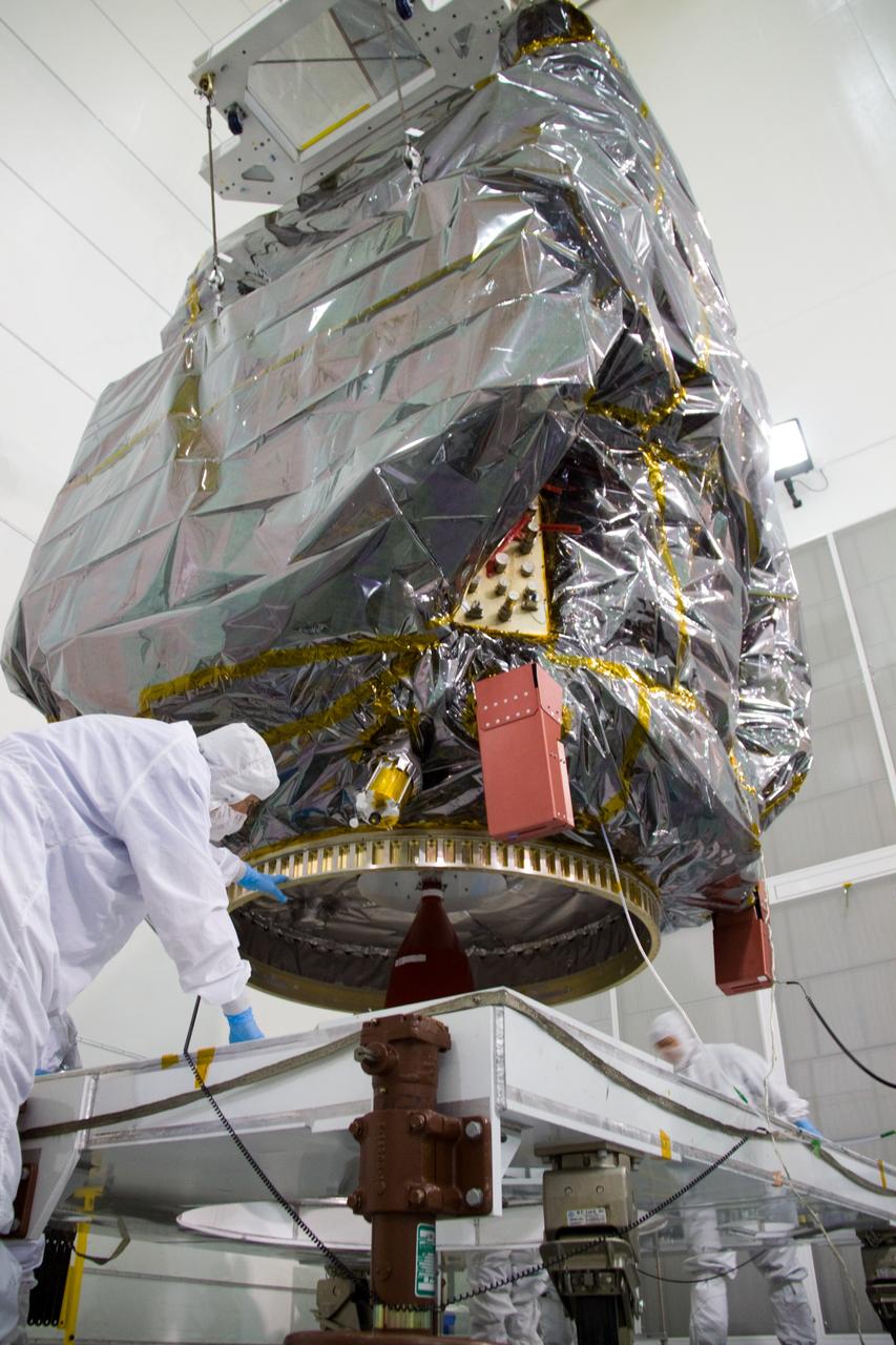 CAPE CANAVERAL, Fla. – At the Astrotech Space Operations facility in Titusville, Fla., technicians from NASA's Goddard Space Flight Center lower the bagged Solar Dynamics Observatory, or SDO, onto a dolly for further processing.    SDO is the first space weather research network mission in NASA's Living With a Star Program. The spacecraft's long-term measurements will give solar scientists in-depth information about changes in the sun's magnetic field and insight into how they affect Earth. Liftoff on an Atlas V rocket is scheduled for Feb. 3, 2010. For information on SDO, visit http://www.nasa.gov/sdo.  Photo credit: NASA/Troy Cryder