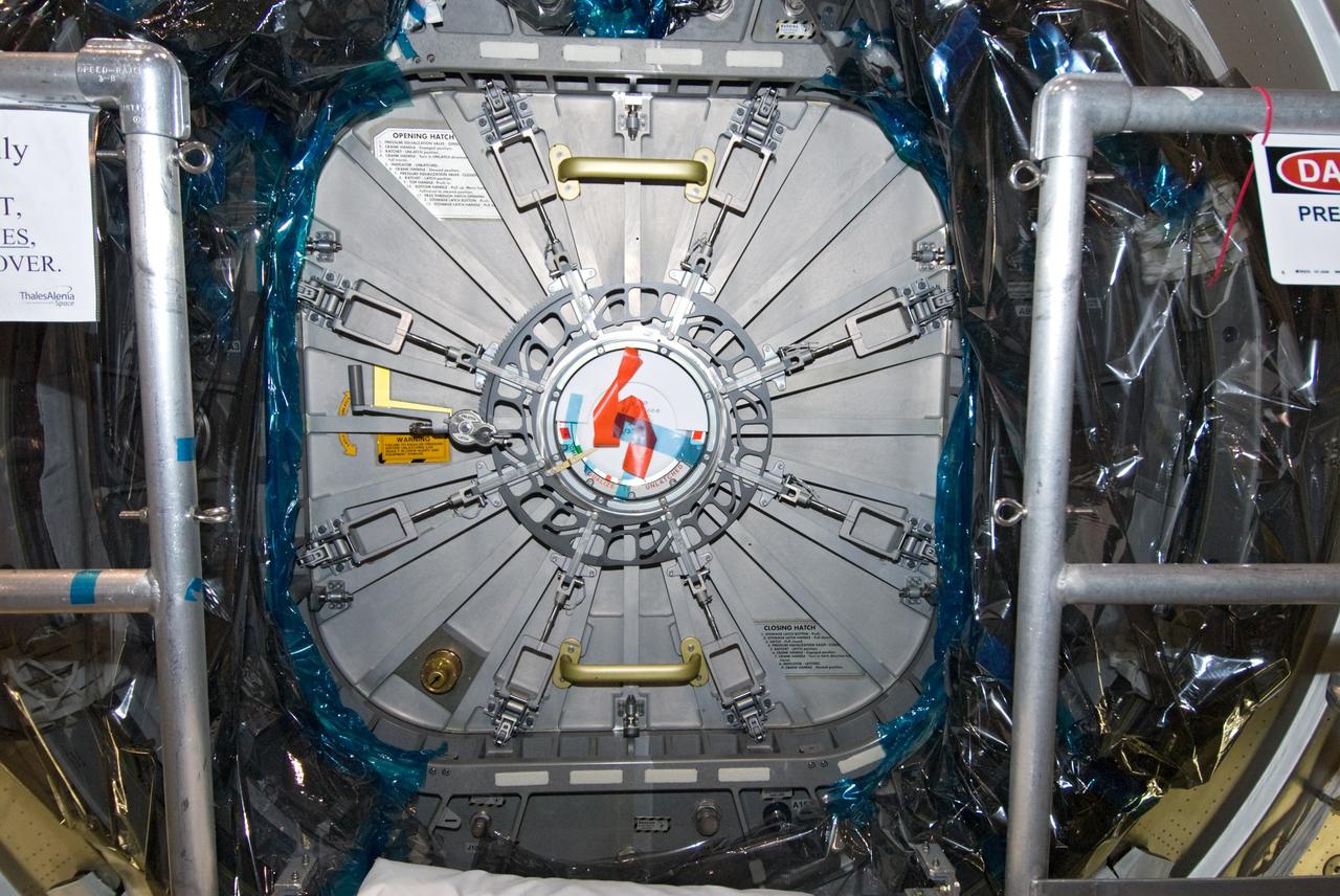CAPE CANAVERAL, Fla. – In the Space Station Processing Facility at NASA's Kennedy Space Center in Florida, the hatch on the International Space Station's Node 3, named Tranquility, is secured.    Hatch closure follows the completion of preparations for the node's transport to the pad and is a significant milestone in launch processing activities. The primary payload for the STS-130 mission, Tranquility is a pressurized module that will provide room for many of the space station's life support systems. Attached to one end of Tranquility is a cupola, a unique work area with six windows on its sides and one on top.  The cupola resembles a circular bay window and will provide a vastly improved view of the station's exterior. The multi-directional view will allow the crew to monitor spacewalks and docking operations, as well as provide a spectacular view of Earth and other celestial objects. The module was built in Turin, Italy, by Thales Alenia Space for the European Space Agency.  Space shuttle Endeavour's STS-130 mission is targeted for launch in early February 2010. For information on the STS-130 mission and crew, visit http://www.nasa.gov/mission_pages/shuttle/shuttlemissions/sts130/index.html.  Photo credit: NASA/Amanda Diller