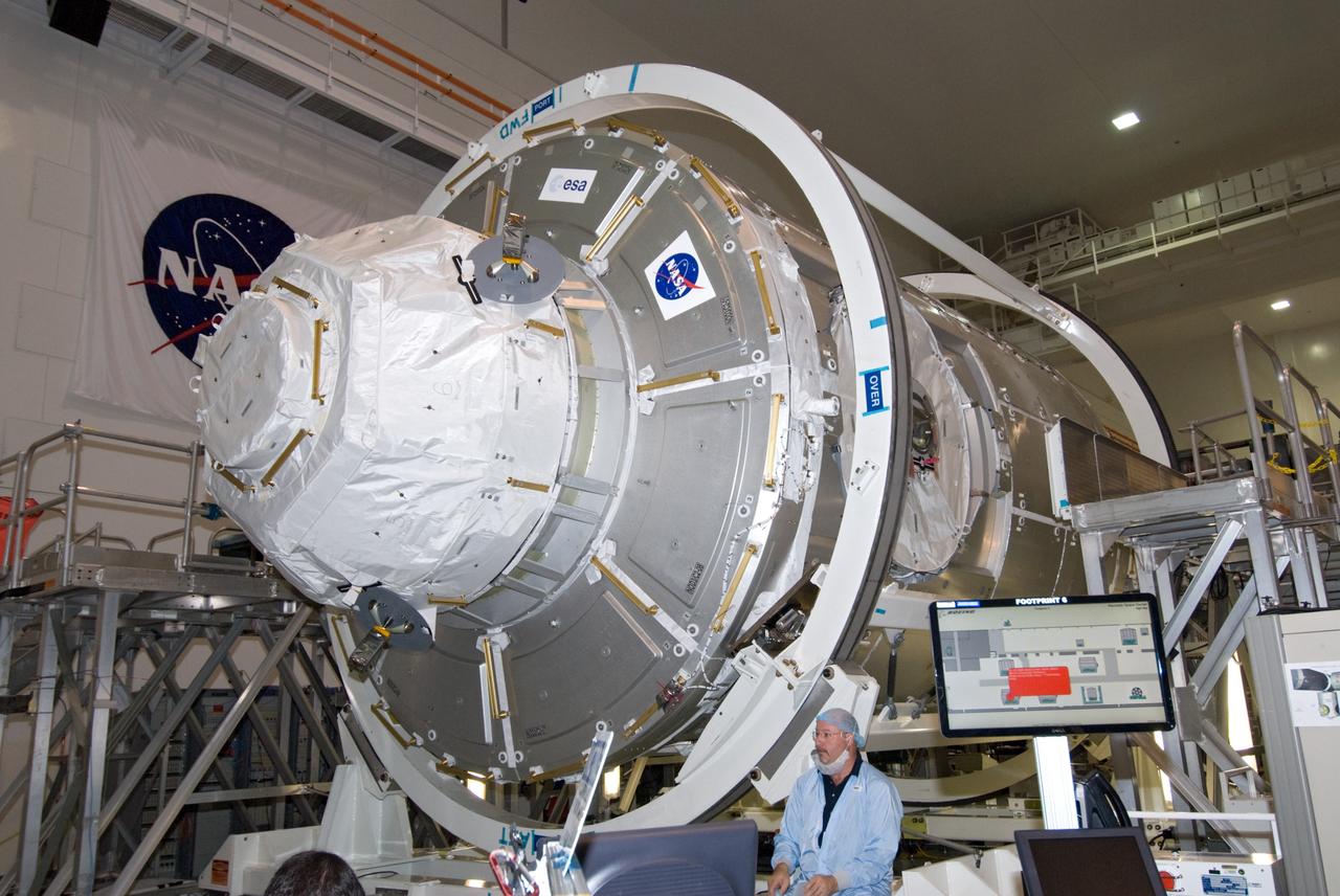 CAPE CANAVERAL, Fla. – In the Space Station Processing Facility at NASA's Kennedy Space Center in Florida, processing of the International Space Station's Node 3, named Tranquility, nears completion.  Its cupola, seen in this view, is covered and its hatch secured.     Hatch closure follows the completion of preparations for the node's transport to the pad and is a significant milestone in launch processing activities. The primary payload for the STS-130 mission, Tranquility is a pressurized module that will provide room for many of the space station's life support systems. Attached to one end of Tranquility is a cupola, a unique work area with six windows on its sides and one on top.  The cupola resembles a circular bay window and will provide a vastly improved view of the station's exterior. The multi-directional view will allow the crew to monitor spacewalks and docking operations, as well as provide a spectacular view of Earth and other celestial objects. The module was built in Turin, Italy, by Thales Alenia Space for the European Space Agency.  Space shuttle Endeavour's STS-130 mission is targeted for launch in early February 2010. For information on the STS-130 mission and crew, visit http://www.nasa.gov/mission_pages/shuttle/shuttlemissions/sts130/index.html.  Photo credit: NASA/Amanda Diller