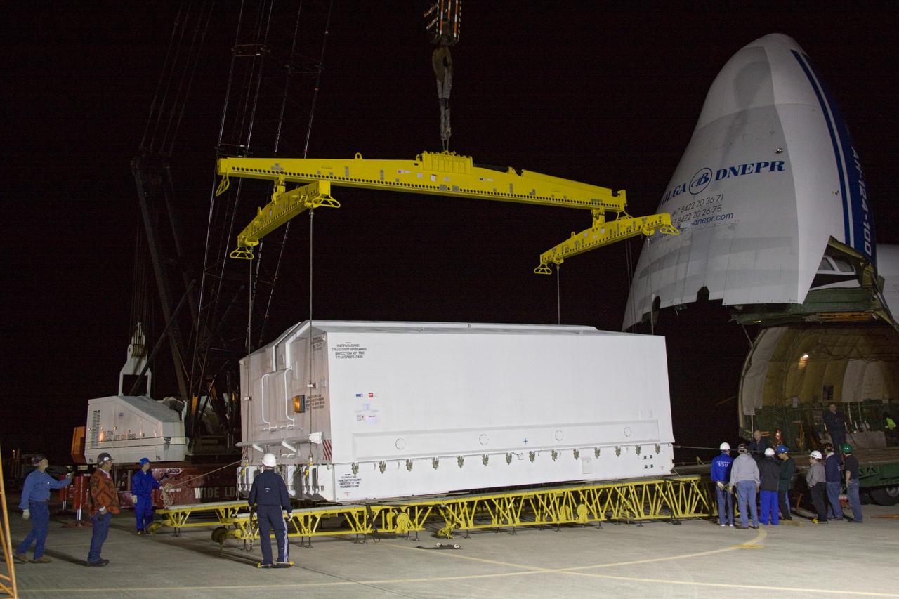 CAPE CANAVERAL, Fla. - At the Shuttle Landing Facility at NASA's Kennedy Space Center in Florida, workers roll the transportation case protecting the Russian-built Mini Research Module1, or MRM1, from the cargo bay of a Volga-Dnepr Antonov AN-124-100, a Ukranian/Russian aircraft. The second in a series of new pressurized components for Russia, the module, named Rassvet, will be permanently attached to the International Space Station's Zarya module on space shuttle Atlantis' STS-132 mission. An Integrated Cargo Carrier will join the MRM in Atlantis' payload bay. Three spacewalks are planned to store spare components outside the station, including six spare batteries, a boom assembly for the Ku-band antenna and spares for the Canadian Dextre robotic arm extension. A radiator, airlock, and European robotic arm for the Russian Multi-purpose Laboratory Module also will be delivered to the station. Launch is targeted for May 14, 2010. Photo credit: NASA/Jack Pfaller