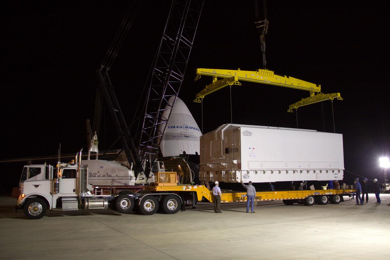 CAPE CANAVERAL, Fla. - At the Shuttle Landing Facility at NASA's Kennedy Space Center in Florida, the transportation case protecting the Russian-built Mini Research Module1, or MRM1, is lifted onto a transporter. The MRM was delivered to Kennedy aboard the Volga-Dnepr Antonov AN-124-100, a Ukranian/Russian aircraft, in the background. The second in a series of new pressurized components for Russia, the module, named Rassvet, will be permanently attached to the International Space Station's Zarya module on space shuttle Atlantis' STS-132 mission. An Integrated Cargo Carrier will join the MRM in Atlantis' payload bay. Three spacewalks are planned to store spare components outside the station, including six spare batteries, a boom assembly for the Ku-band antenna and spares for the Canadian Dextre robotic arm extension. A radiator, airlock, and European robotic arm for the Russian Multi-purpose Laboratory Module also will be delivered to the station. Launch is targeted for May 14, 2010. Photo credit: NASA/Jack Pfaller