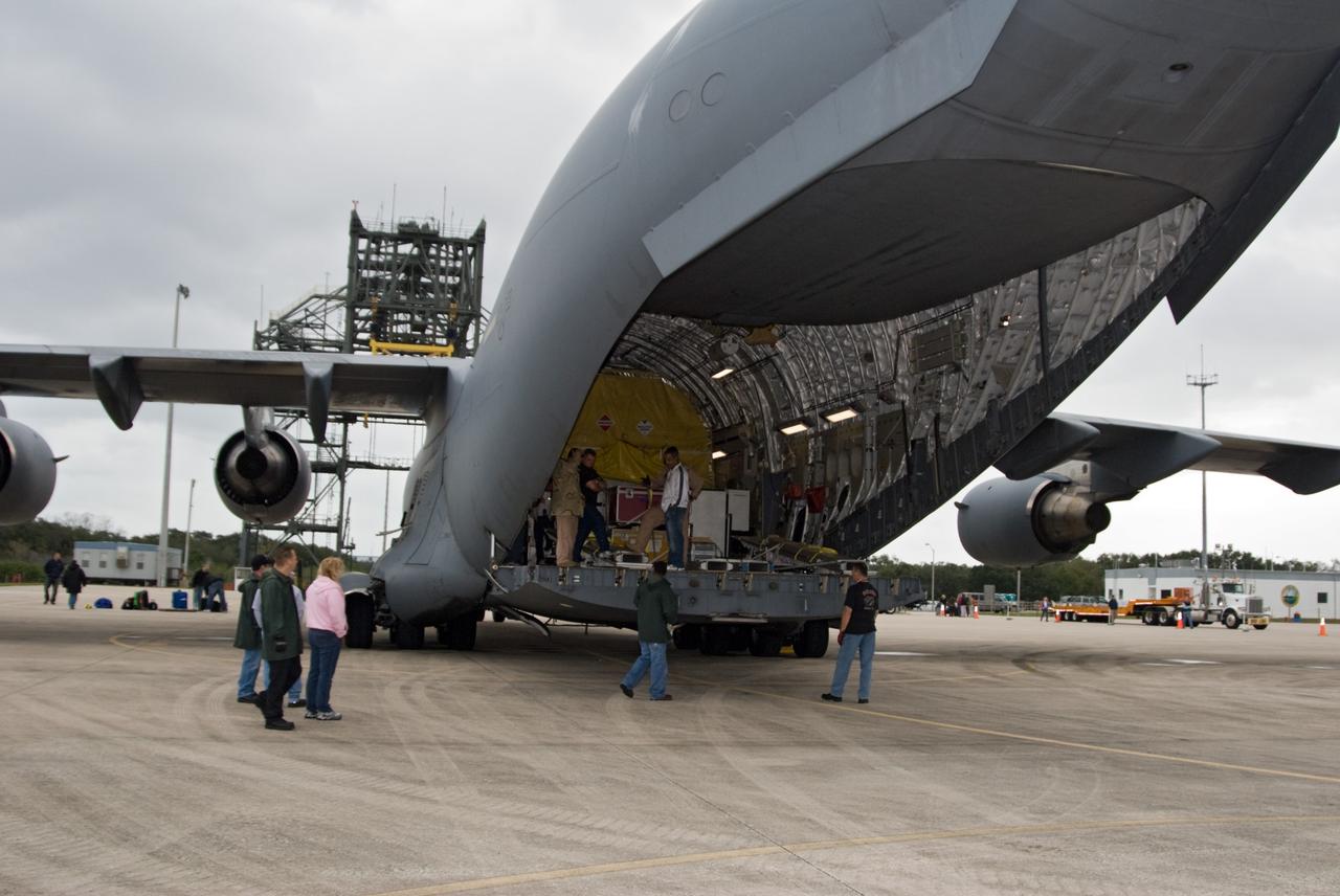 CAPE CANAVERAL, Fla. – Workers prepare to offload NASA's GOES-P meteorological satellite from a U.S. Air Force C-17 aircraft at the Shuttle Landing Facility at NASA's Kennedy Space Center in Florida. GOES-P, the latest Geostationary Operational Environmental Satellite, was developed by NASA for the National Oceanic and Atmospheric Administration, or NOAA. GOES-P is designed to watch for storm development and observed current weather conditions on Earth. Launch of GOES-P is targeted for no earlier than Feb. 25, 2010, from Launch Complex 37 aboard a United Launch Alliance Delta IV rocket. For information on GOES-P, visit http://goespoes.gsfc.nasa.gov/goes/spacecraft/n_p_spacecraft.html. Photo credit: NASA/Amanda Diller