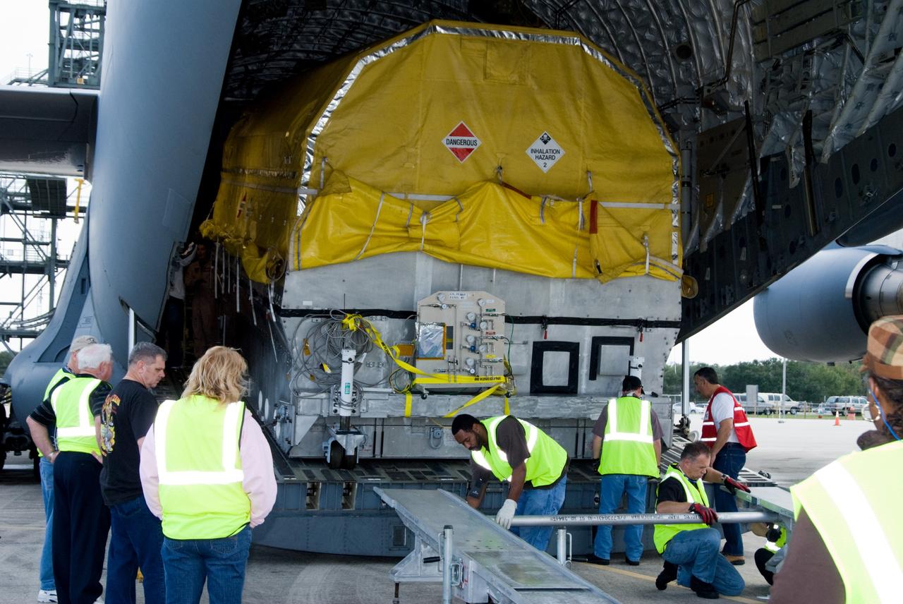 CAPE CANAVERAL, Fla. – At the Shuttle Landing Facility at NASA's Kennedy Space Center in Florida, workers set up a ramp to assist with the offloading of NASA's GOES-P meteorological satellite from the cargo bay of a U.S. Air Force C-17 aircraft. GOES-P, the latest Geostationary Operational Environmental Satellite, was developed by NASA for the National Oceanic and Atmospheric Administration, or NOAA. GOES-P is designed to watch for storm development and observed current weather conditions on Earth. Launch of GOES-P is targeted for no earlier than Feb. 25, 2010, from Launch Complex 37 aboard a United Launch Alliance Delta IV rocket. For information on GOES-P, visit http://goespoes.gsfc.nasa.gov/goes/spacecraft/n_p_spacecraft.html. Photo credit: NASA/Amanda Diller