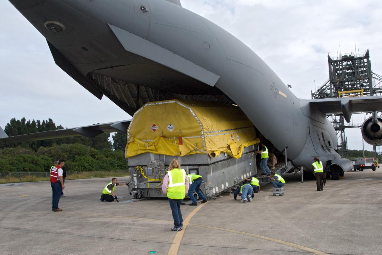 CAPE CANAVERAL, Fla. – At the Shuttle Landing Facility at NASA's Kennedy Space Center in Florida, workers roll NASA's GOES-P meteorological satellite from the cargo bay of a U.S. Air Force C-17 aircraft. GOES-P, the latest Geostationary Operational Environmental Satellite, was developed by NASA for the National Oceanic and Atmospheric Administration, or NOAA. GOES-P is designed to watch for storm development and observed current weather conditions on Earth. Launch of GOES-P is targeted for no earlier than Feb. 25, 2010, from Launch Complex 37 aboard a United Launch Alliance Delta IV rocket. For information on GOES-P, visit http://goespoes.gsfc.nasa.gov/goes/spacecraft/n_p_spacecraft.html. Photo credit: NASA/Amanda Diller